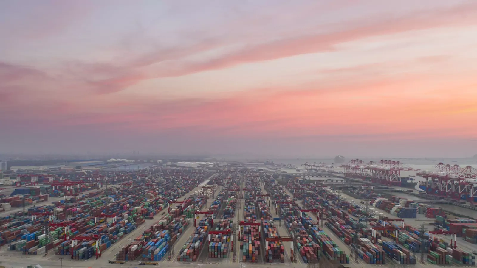 The sun sets over the Port of Shanghai.