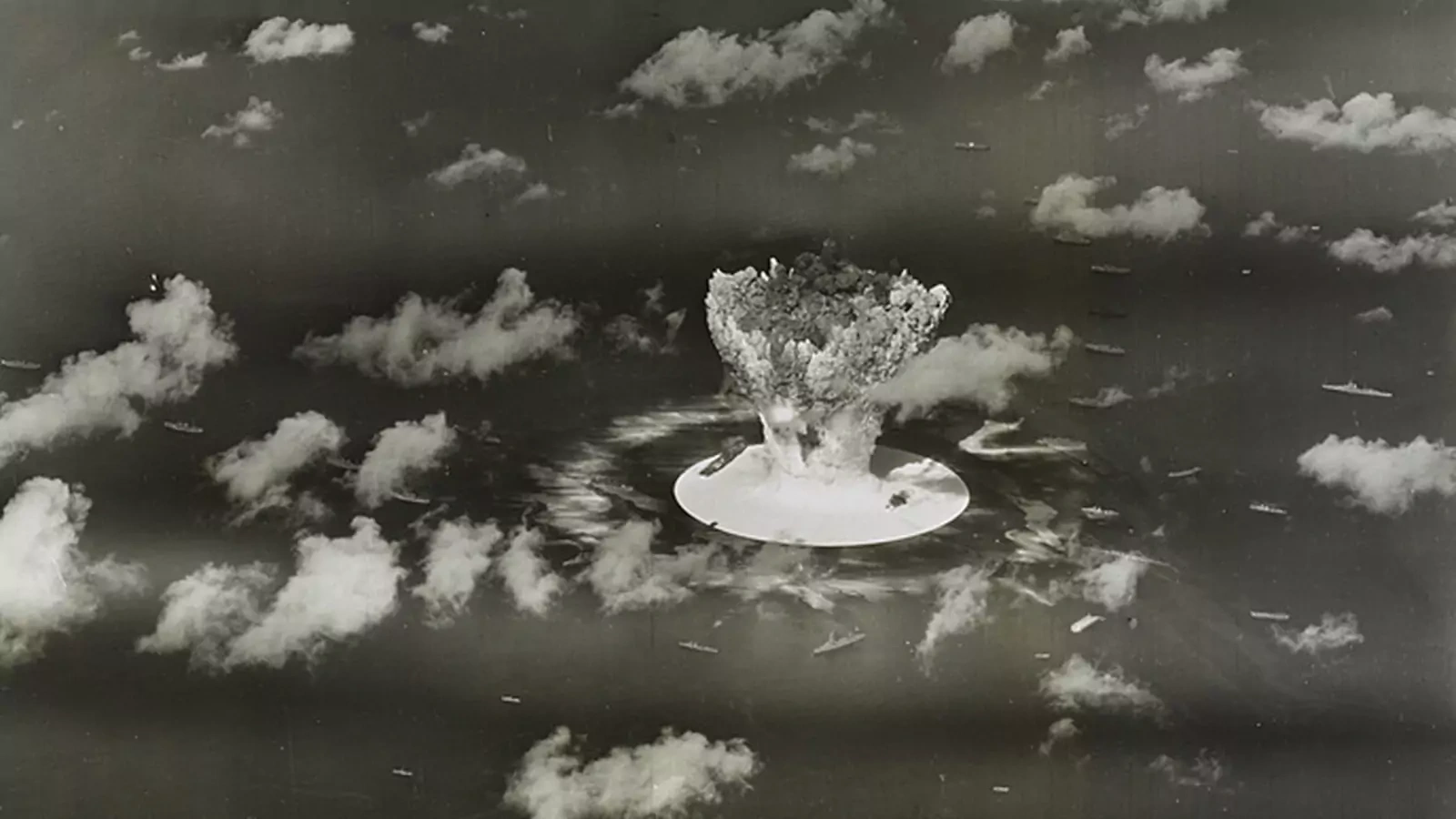 A mushroom cloud rises with ships below during the Operation Crossroads nuclear weapons test on Bikini Atoll, Marshall Islands.