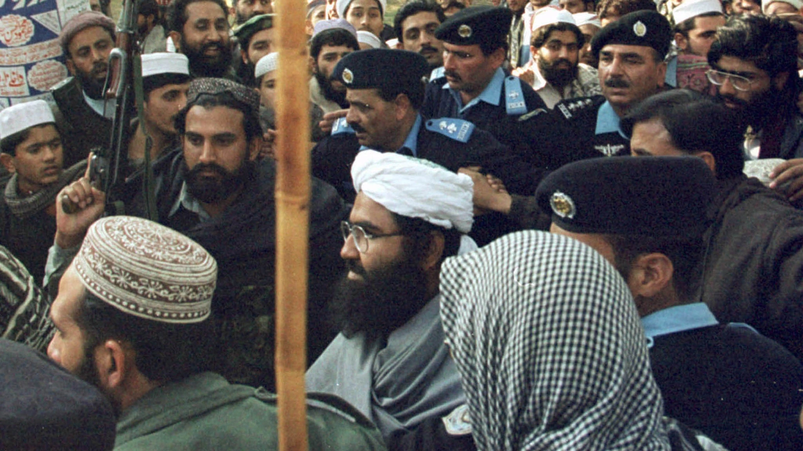 Masood Azhar is surrounded by Pakistani police and his armed guards at Islamabad's Lal Mosque (Red Mosque) in Melody Market January 27, 2000.