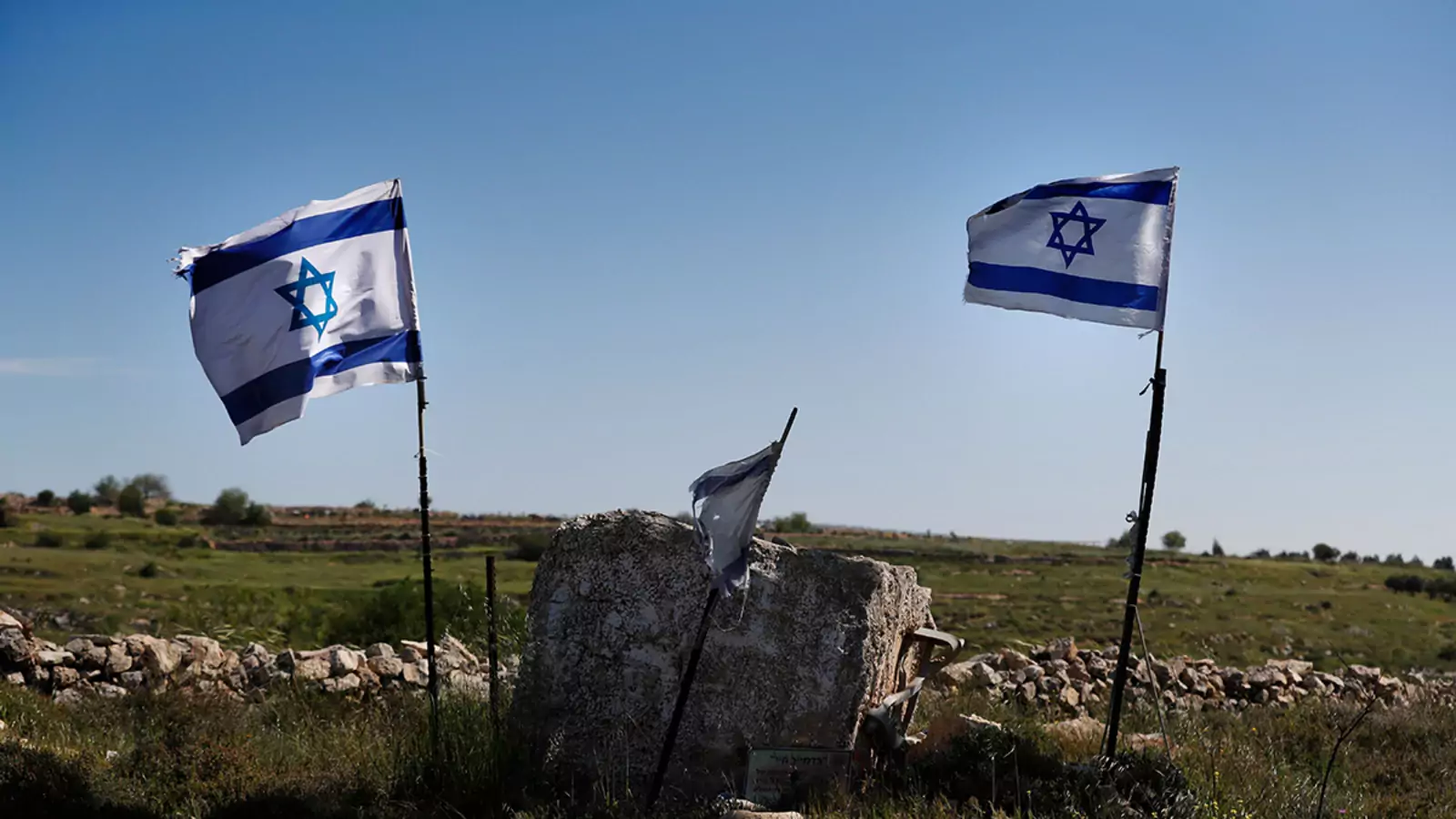 Israeli flags in front of a partial view of the Israeli settlement of Efrat situated on the southern outskirts of the West Bank city of Bethlehem.