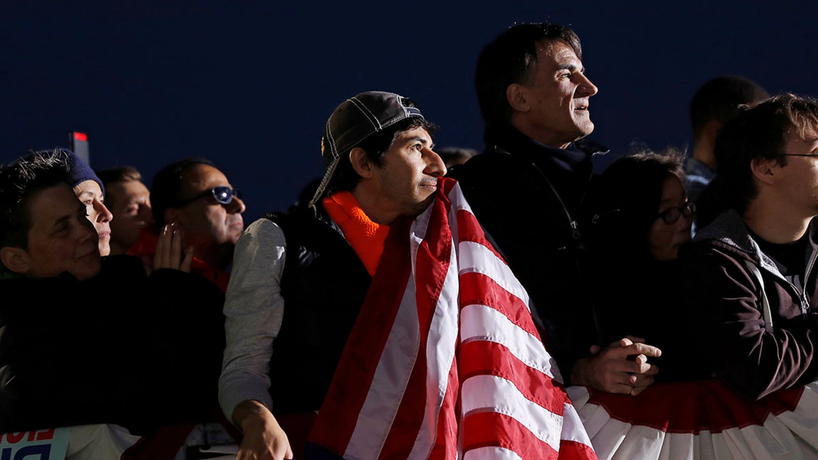 U.S. Air Force veteran Gerardo Marin holds a flag while listening to 2020 Democratic presidential candidate U.S. Sen. Elizabeth Warren (D-MA) during a town hall event in Oakland, California.