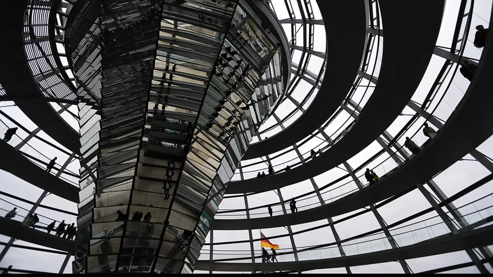 People walk inside the dome of the Reichstag building in Berlin. 