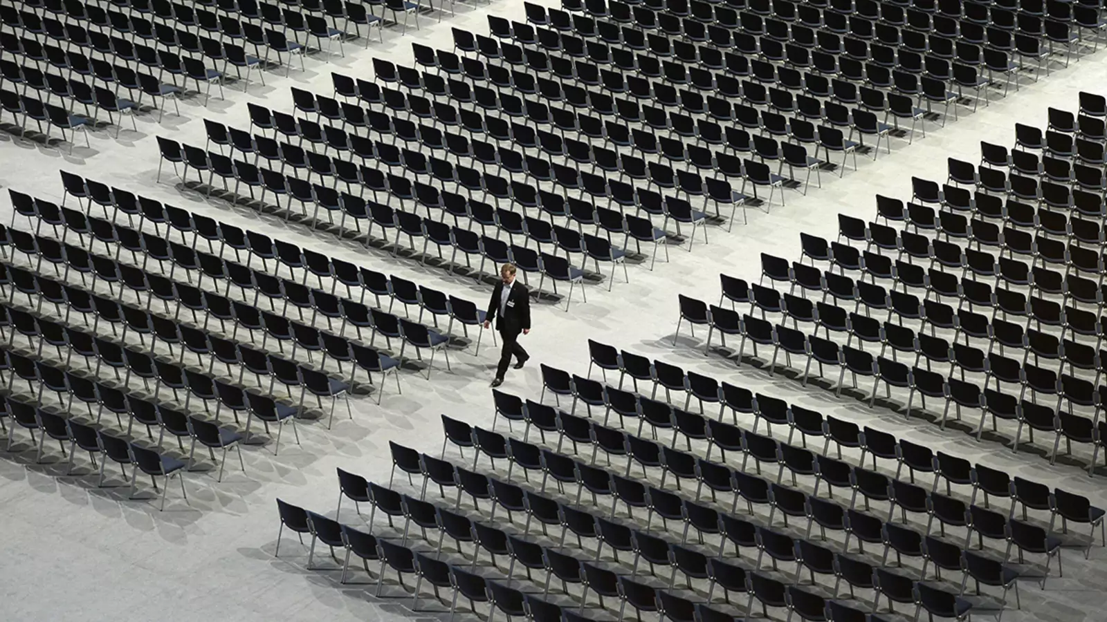 A man walks between empty seats ahead the shareholders meeting of the German engineering giant Siemens in the Olympic hall in Munich, southern Germany, on January 27, 2015. 