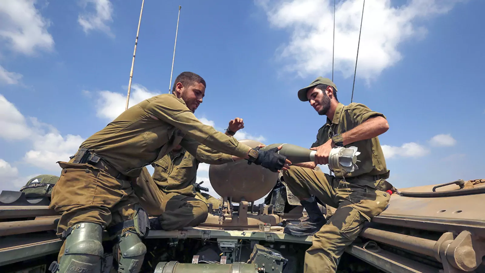 Israeli soldiers charge a mortar shell near the border with Syria.