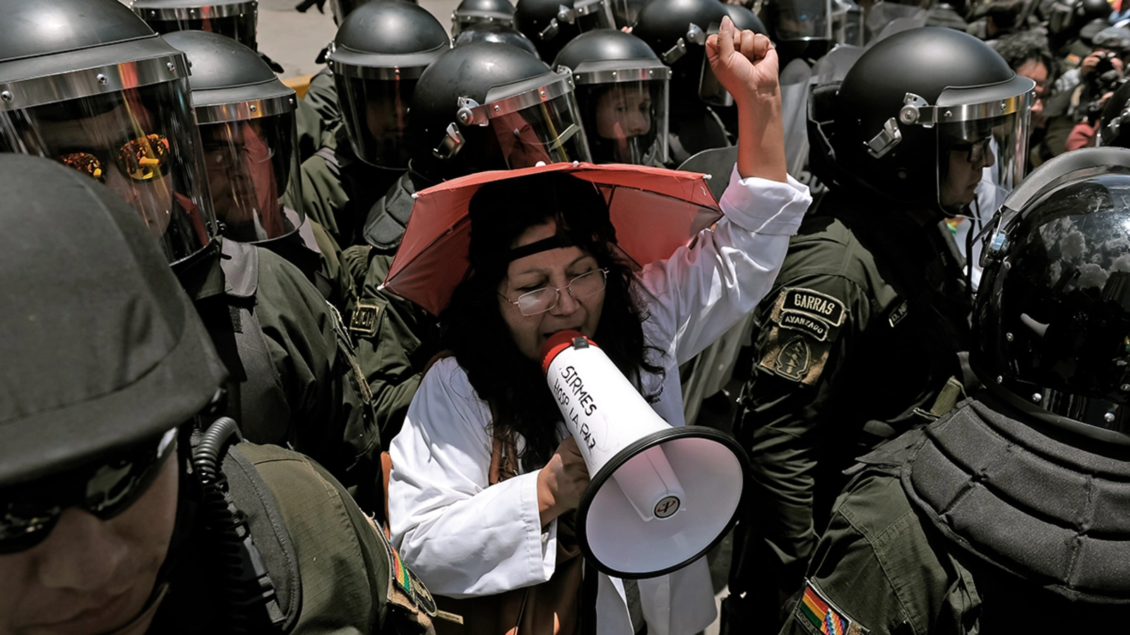 Health workers demonstrate outside the hotel where the Supreme Electoral Tribunal has its headquarters to count the election votes, in La Paz, on October 22, 2019.