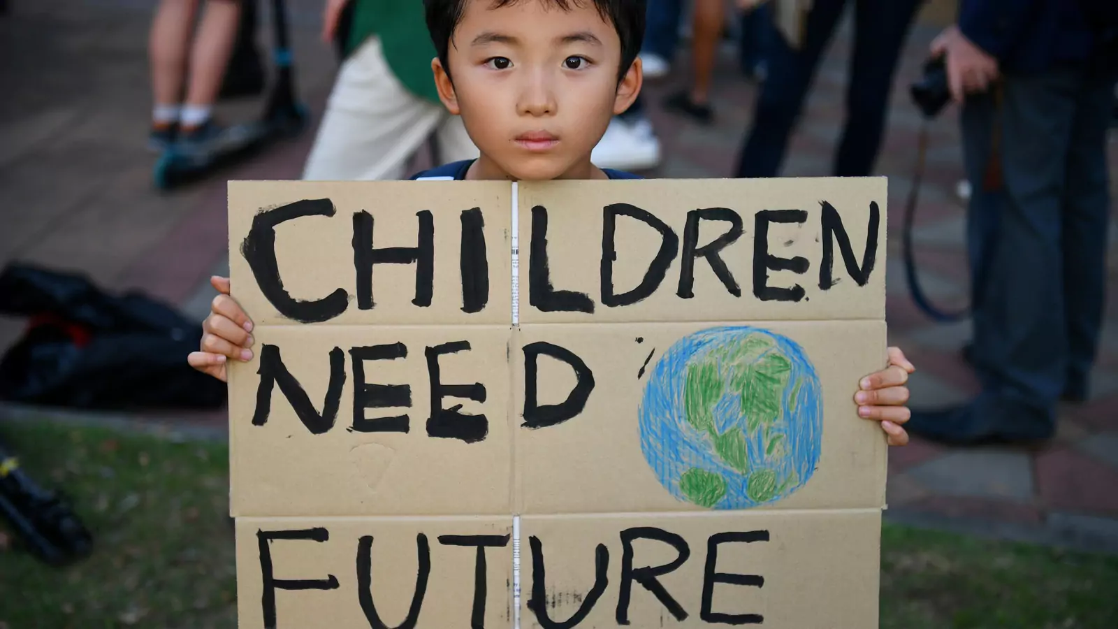 A child holds a placard during a protest against climate change consequences in Bangkok, Thailand on November 29, 2019. 