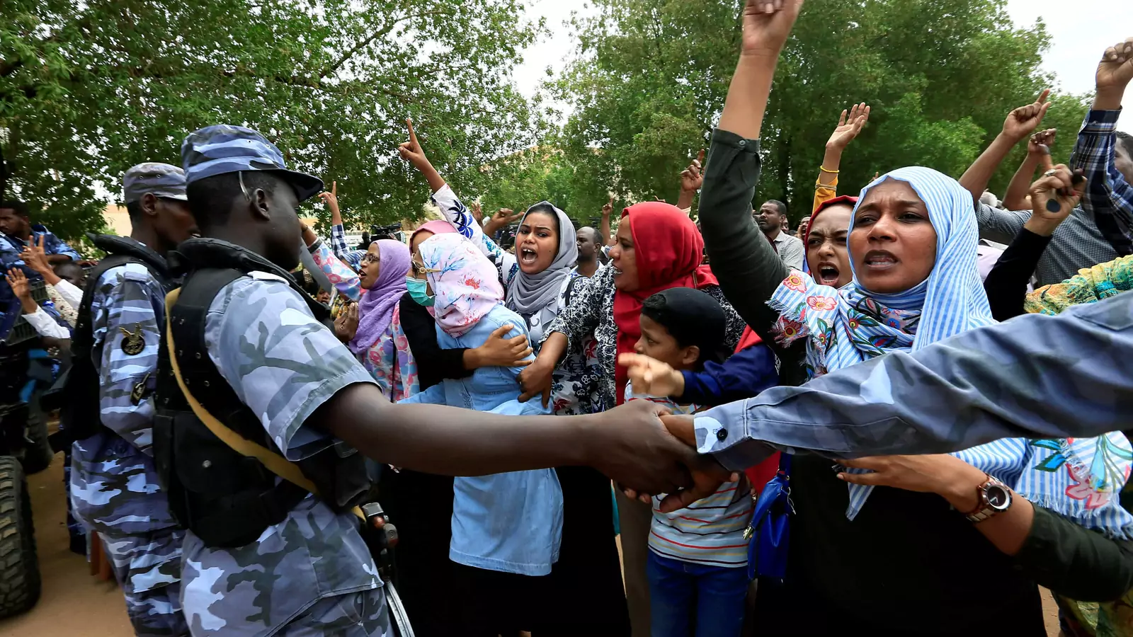 Sudanese chant slogans outside a court during a new trial against ousted President Omar al-Bashir and some of his former allies over the military coup that brought the autocrat to power in 1989, outside a courthouse in Khartoum, Sudan. September 15, 2020