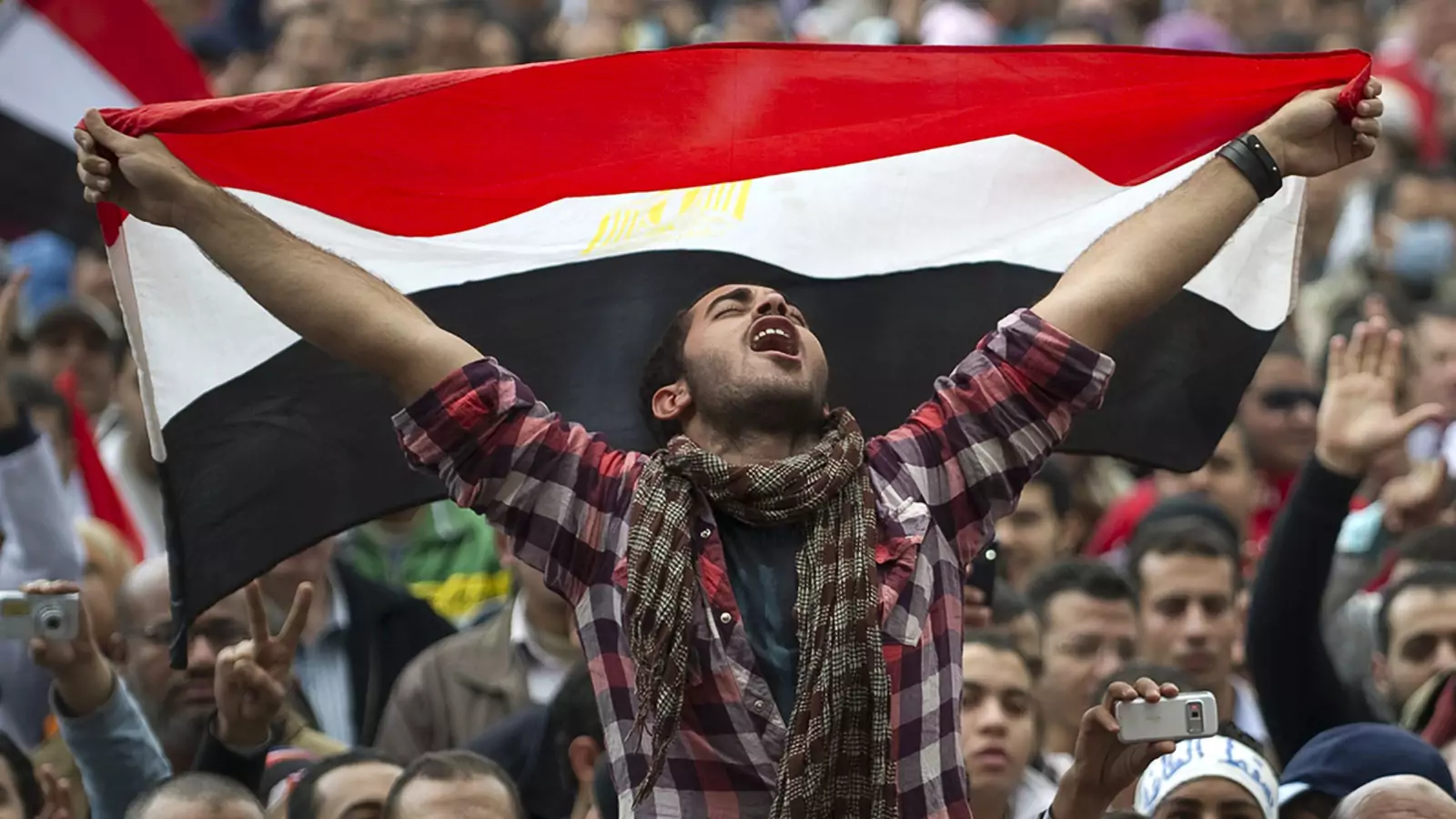 An Egyptian protester holds his national flag as he shouts slogans against President Hosni Mubarak at Cairo’s Tahrir Square in 2011.