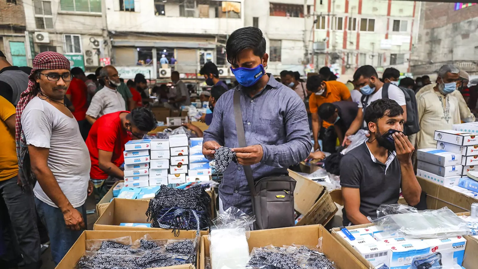 A shopper peruses a mask market in Dhaka, Bangladesh, as coronavirus cases increase in April 2021.