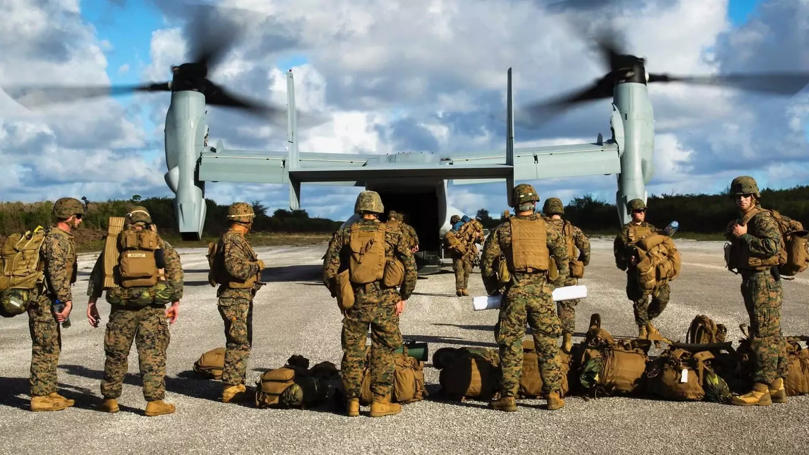 An MV-22B Osprey disembarks marines on a runway in Guam. 