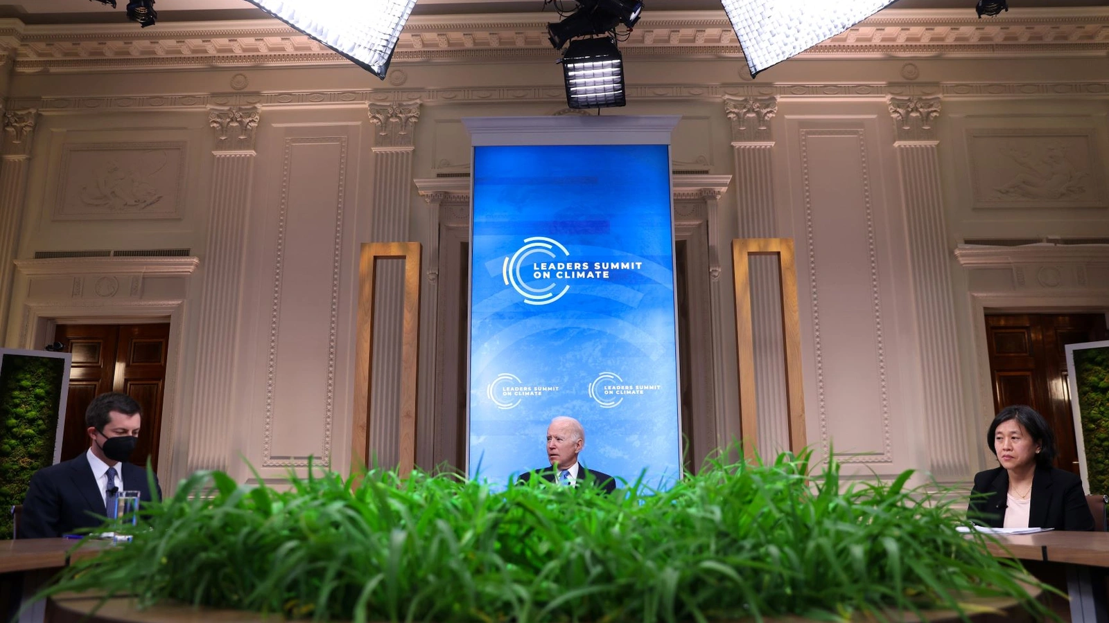 U.S. President Joe Biden looks on between Transportation Secretary Pete Buttigieg, left, and United States Trade Representative Katherine Tai, right, during a virtual Climate Summit with world leaders in the East Room at the White House in Washington, D.C