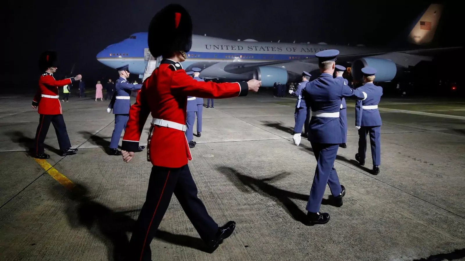 Military personnel march to welcome U.S. President Joe Biden and first lady Jill Biden upon the arrival of Air Force One at Cornwall Airport in Britain on June 9, 2021. 