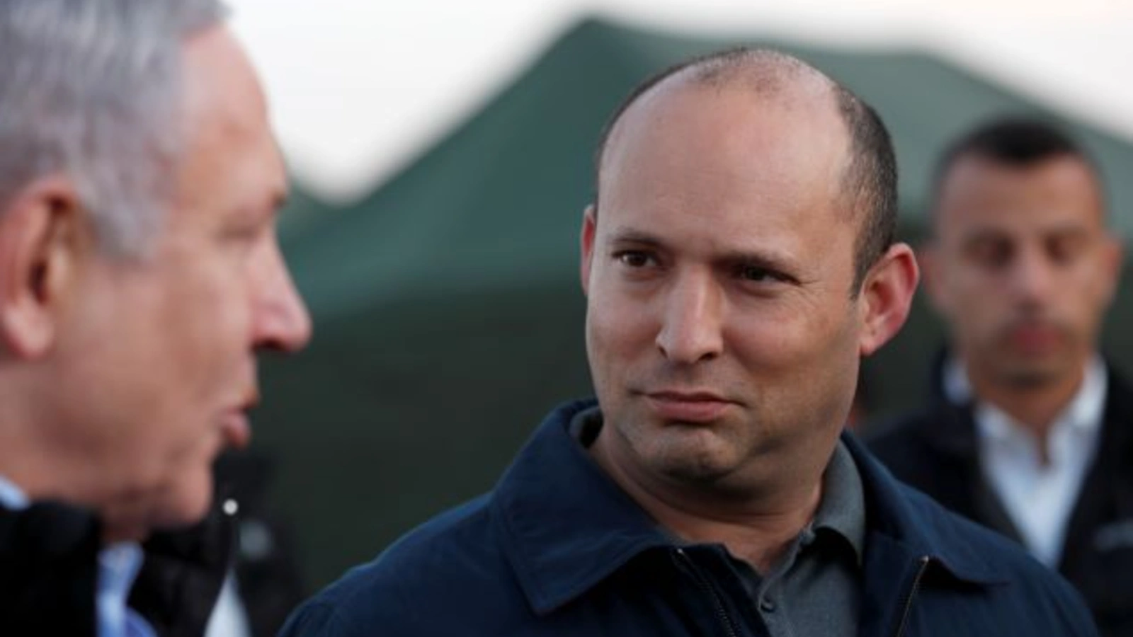 Israeli Defense Minister Naftali Bennett looks at Prime Minister Benjamin Netanyahu during a visit to an Israeli army base in the Israeli-occupied Golan Heights, November 24, 2019.