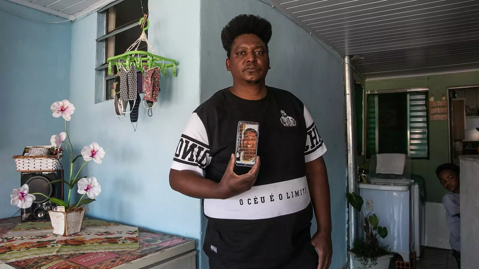 Marcelo Louzada holds a photo of his brother Valdemar Louzada, thirty-eight, in Sao Paulo, Brazil. Valdemar suffered from obesity and died from COVID-19 in May 2020.