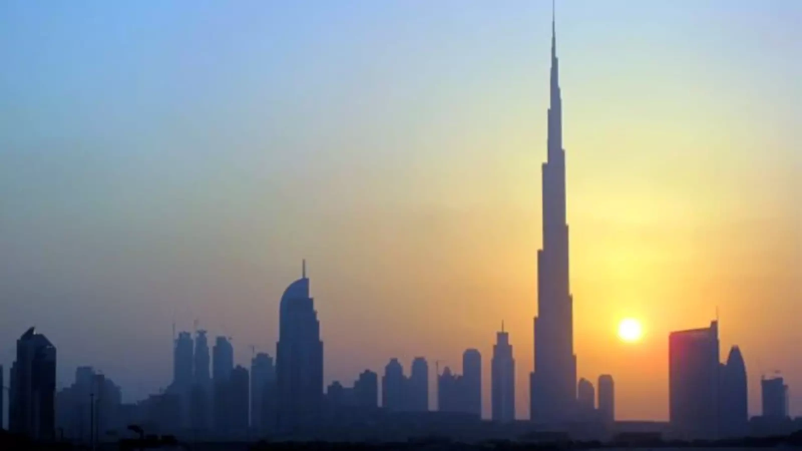 The Burj Khalifa (C) skyscraper is seen as the sun sets over Dubai October 5, 2010.