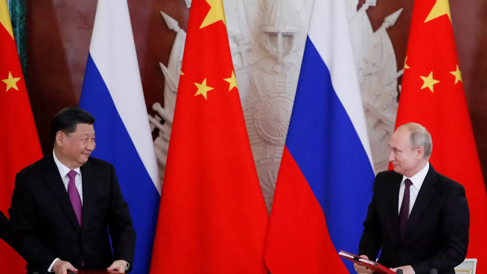 Russian President Vladimir Putin and his Chinese counterpart Xi Jinping look on during a signing ceremony in Moscow, Russia, June 5, 2019.
