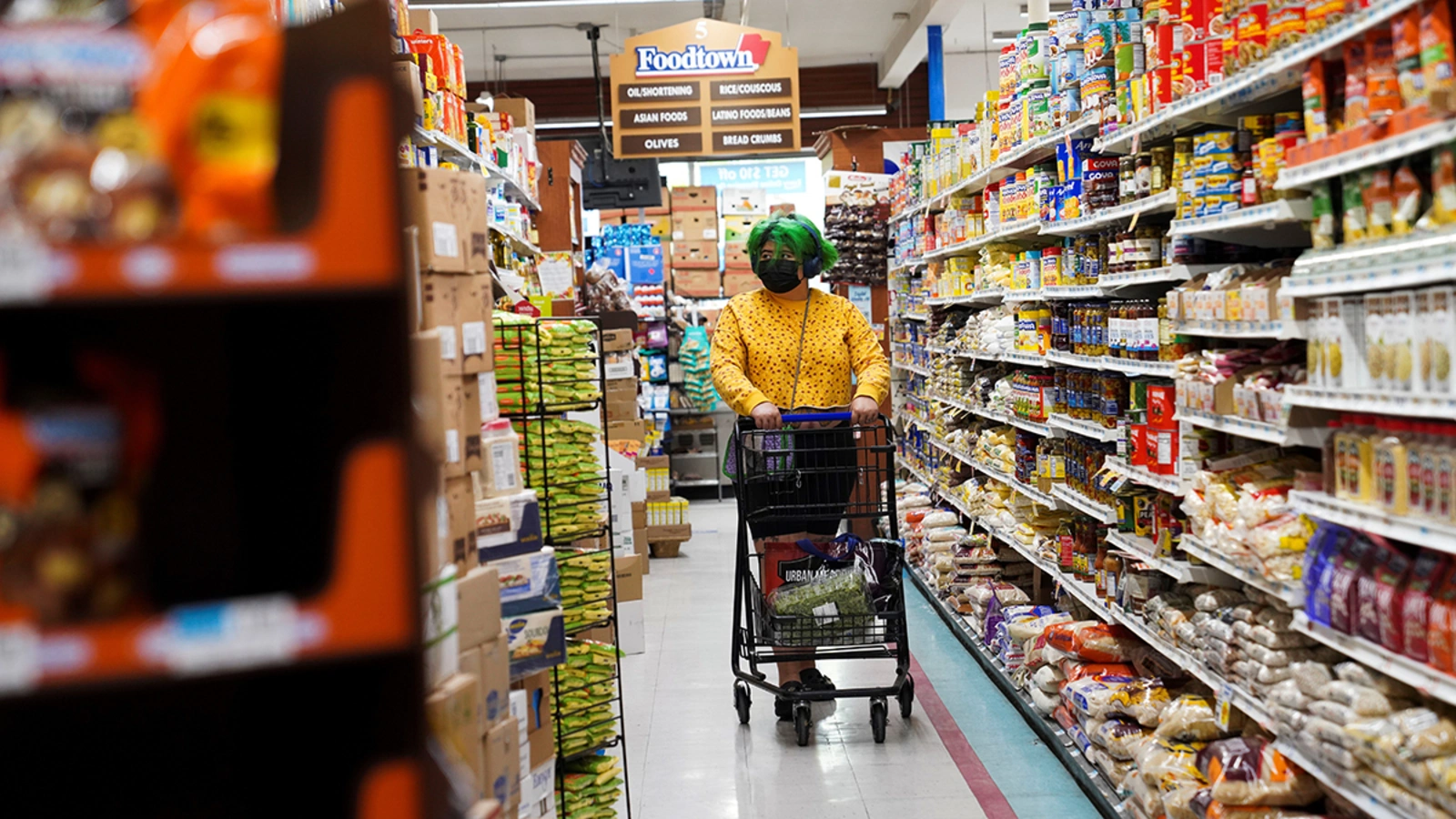 A customer shops at a store in New York City in May 2022 as annual inflation surpasses 8 percent. 