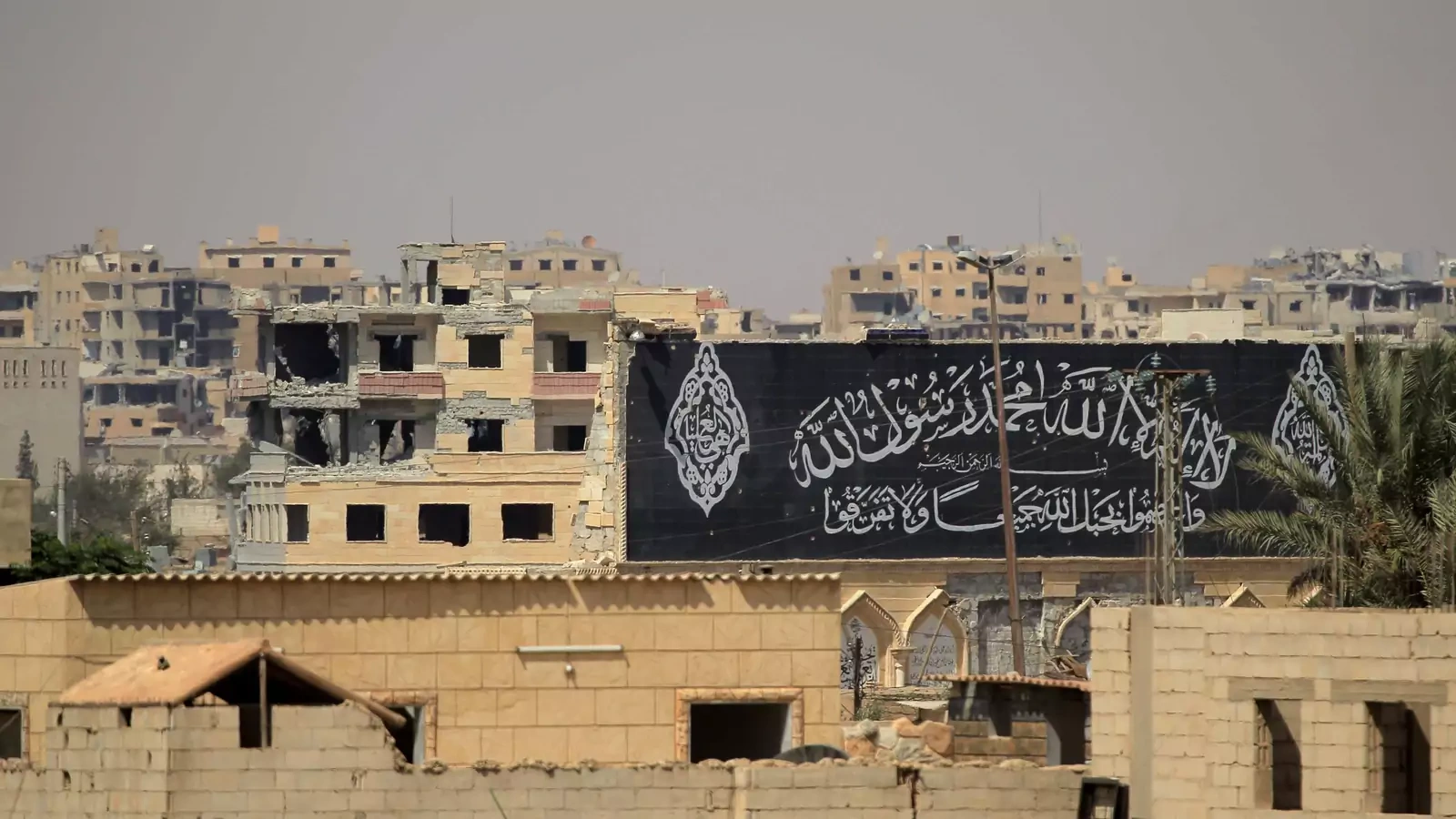 A banner belonging to Islamic State fighters is seen during a battle with members of the Syrian Democratic Forces in Raqqa, Syria, on August 16, 2017.