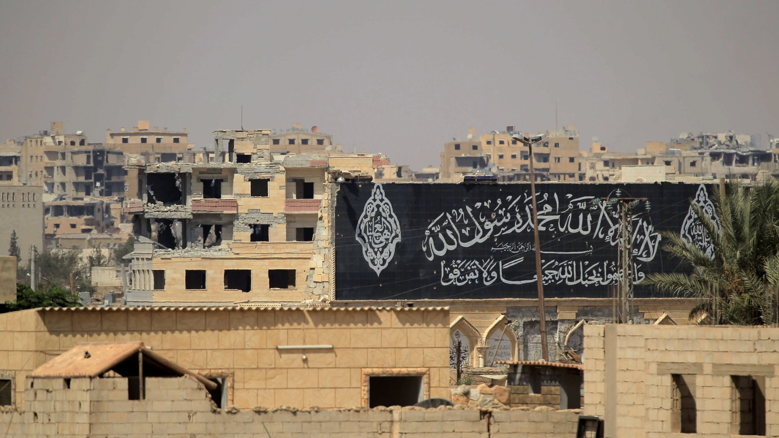 A banner belonging to Islamic State fighters is seen during a battle with members of the Syrian Democratic Forces in Raqqa, Syria, on August 16, 2017.