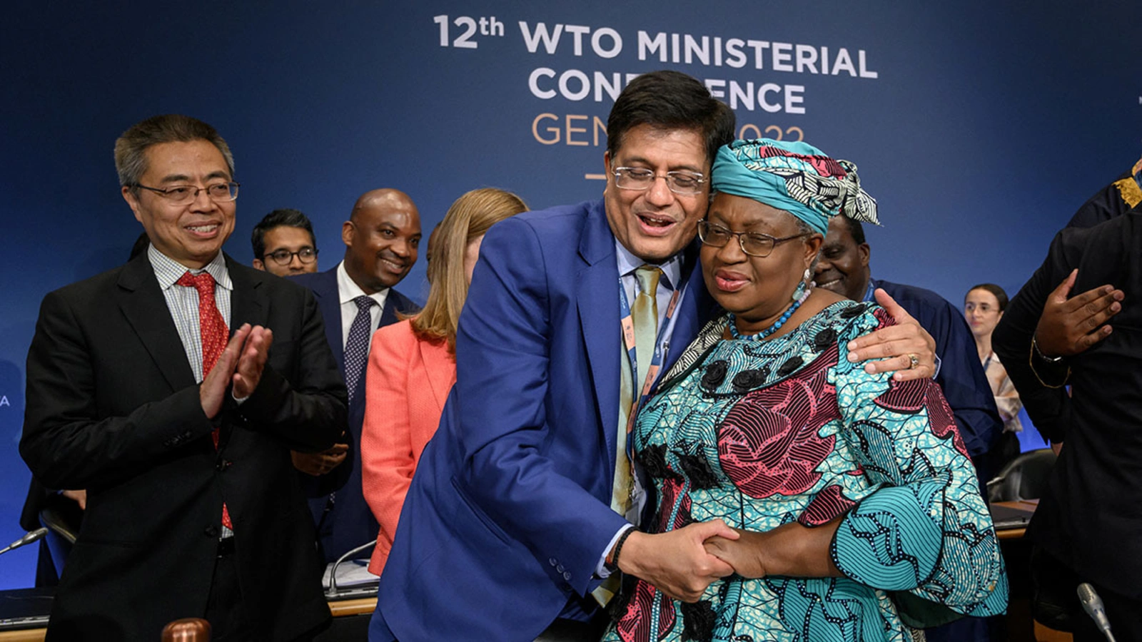 WTO Director-General Ngozi Okonjo-Iweala (right) is congratulated by Indian Commerce Minister Piyush Goyal after a closing session of a WTO ministerial conference in Geneva in June 2022.