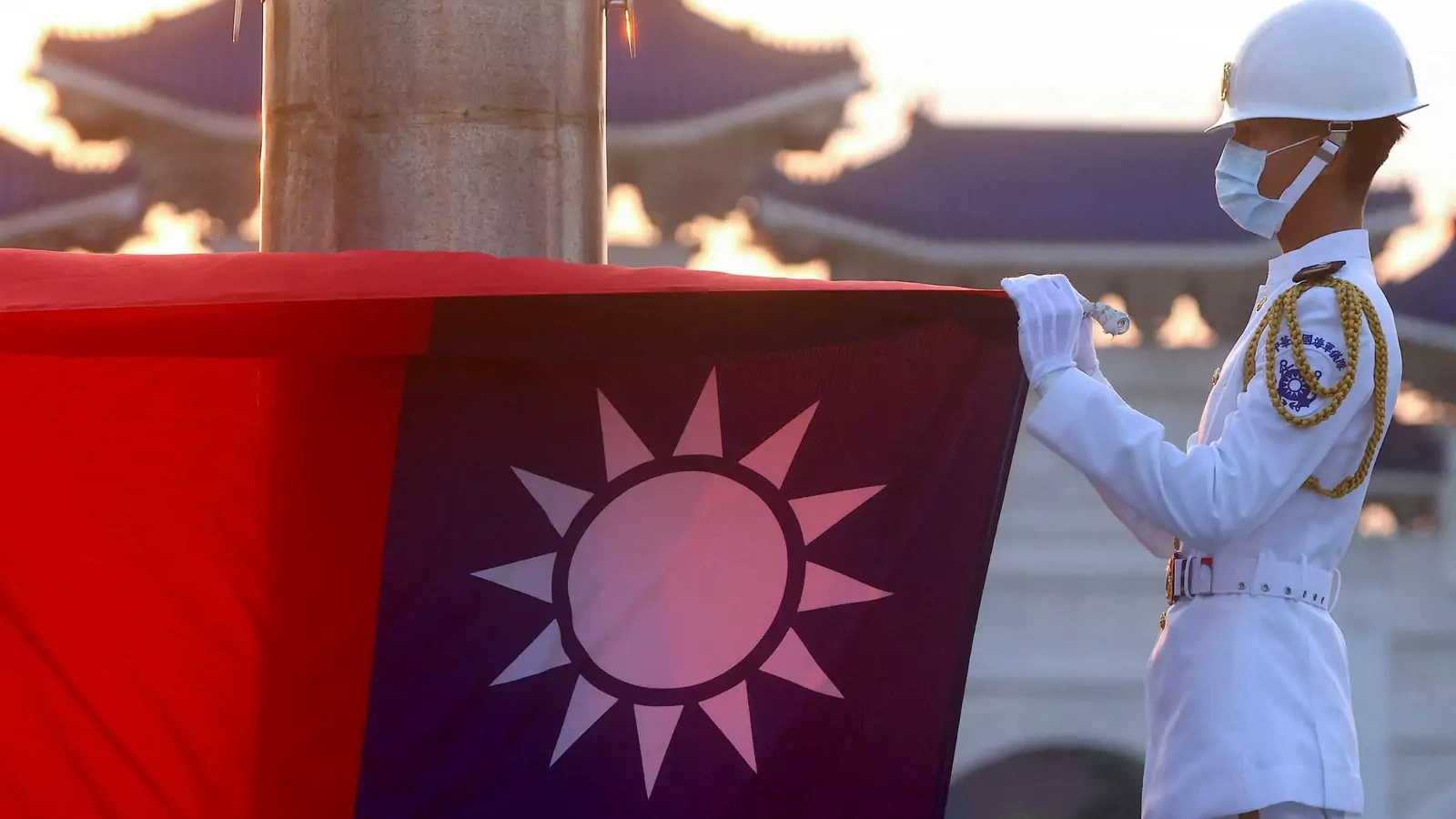 Honor guards lower the Taiwan flag during sunset hours at Liberty Square in Taipei.