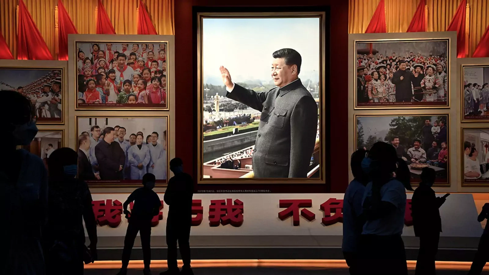 People stand in front of images of Chinese leader Xi Jinping at the Museum of the Chinese Communist Party in Beijing.