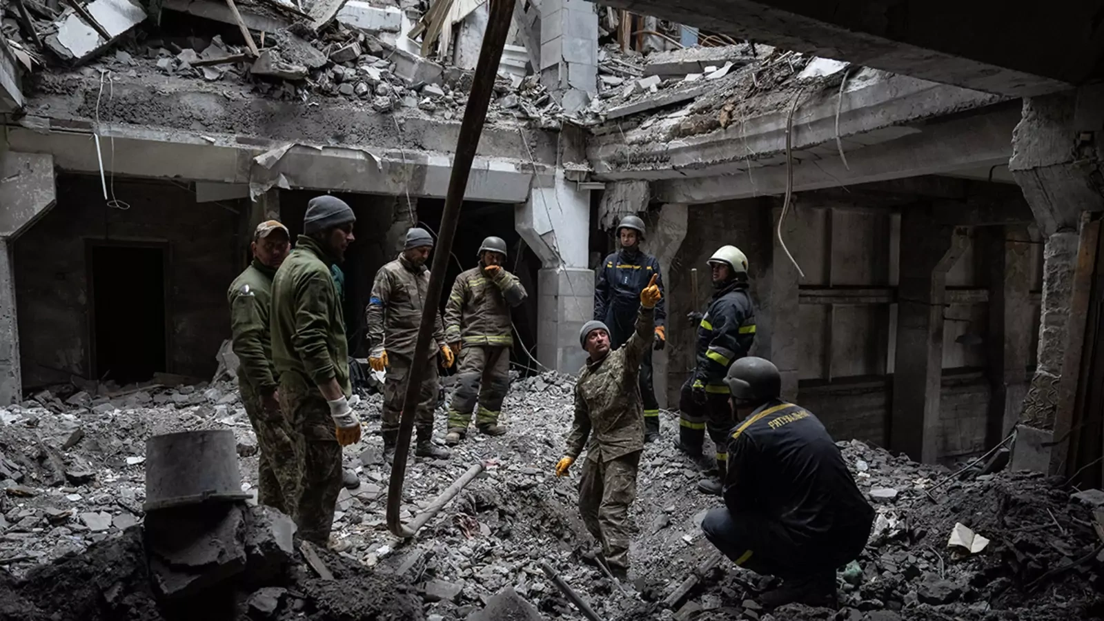 A soldier searches for bodies in a building struck by a Russian missile on October 13, 2022 in Kupiansk, Kharkiv oblast, Ukraine.