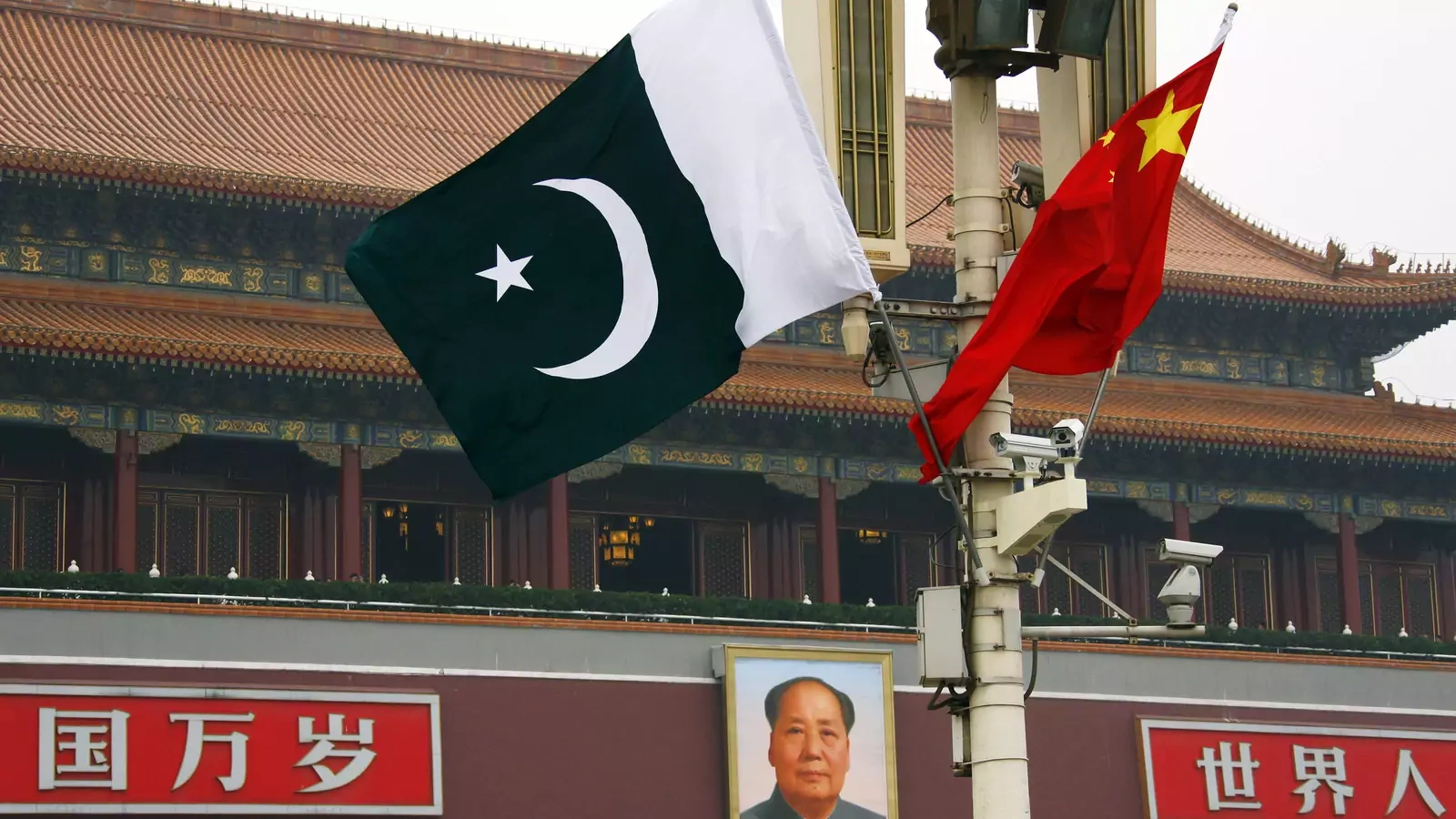 A Pakistani national flag flies alongside a Chinese national flag in front of the portrait of Chairman Mao Zedong on Beijing's Tiananmen Square.