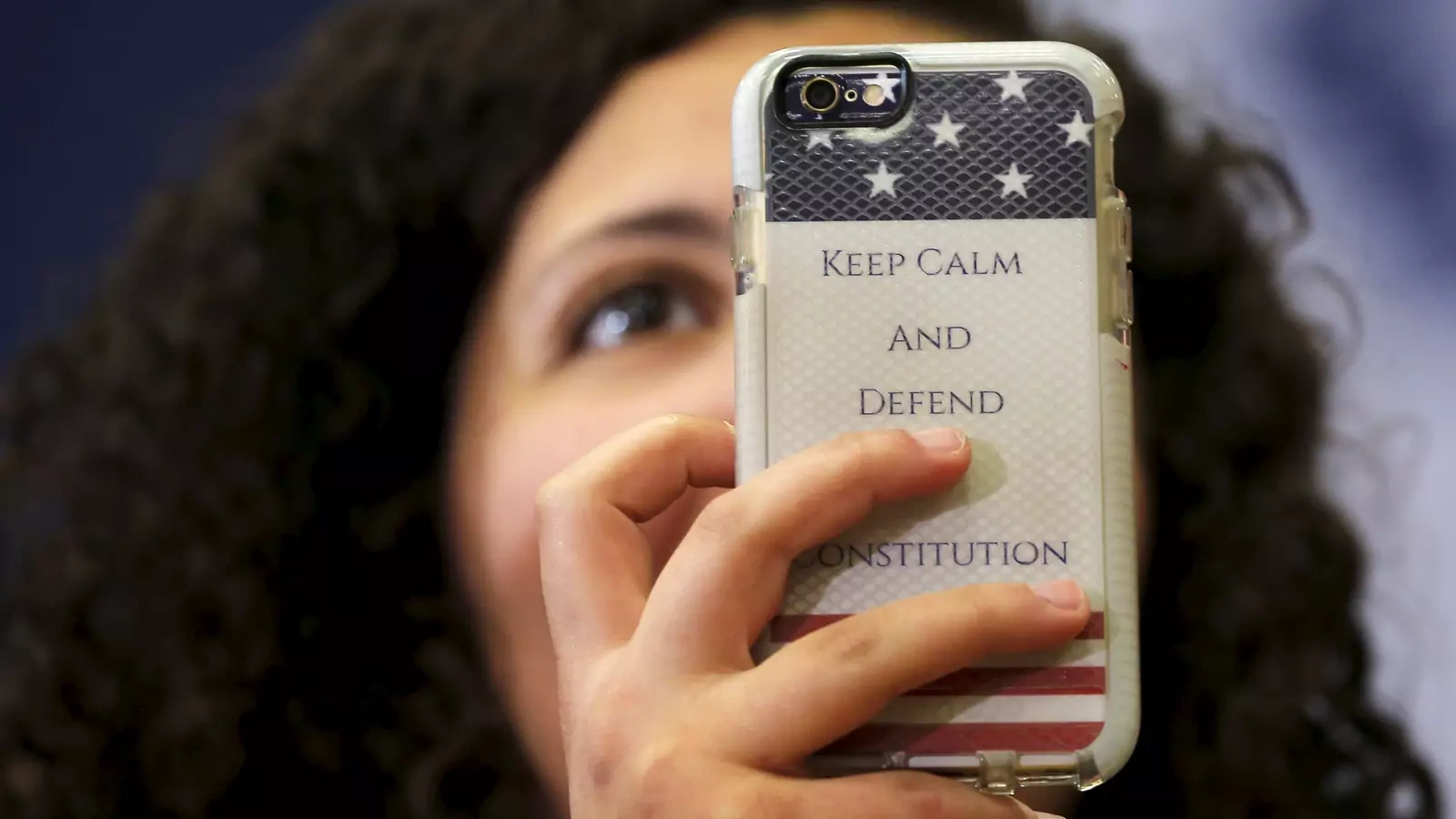 An audience member holds up a phone with a case reading "Keep Calm and Defend the Constitution" during a "Get Out to Caucus" rally with U.S. Democratic presidential candidate Hillary Clinton in Cedar Rapids