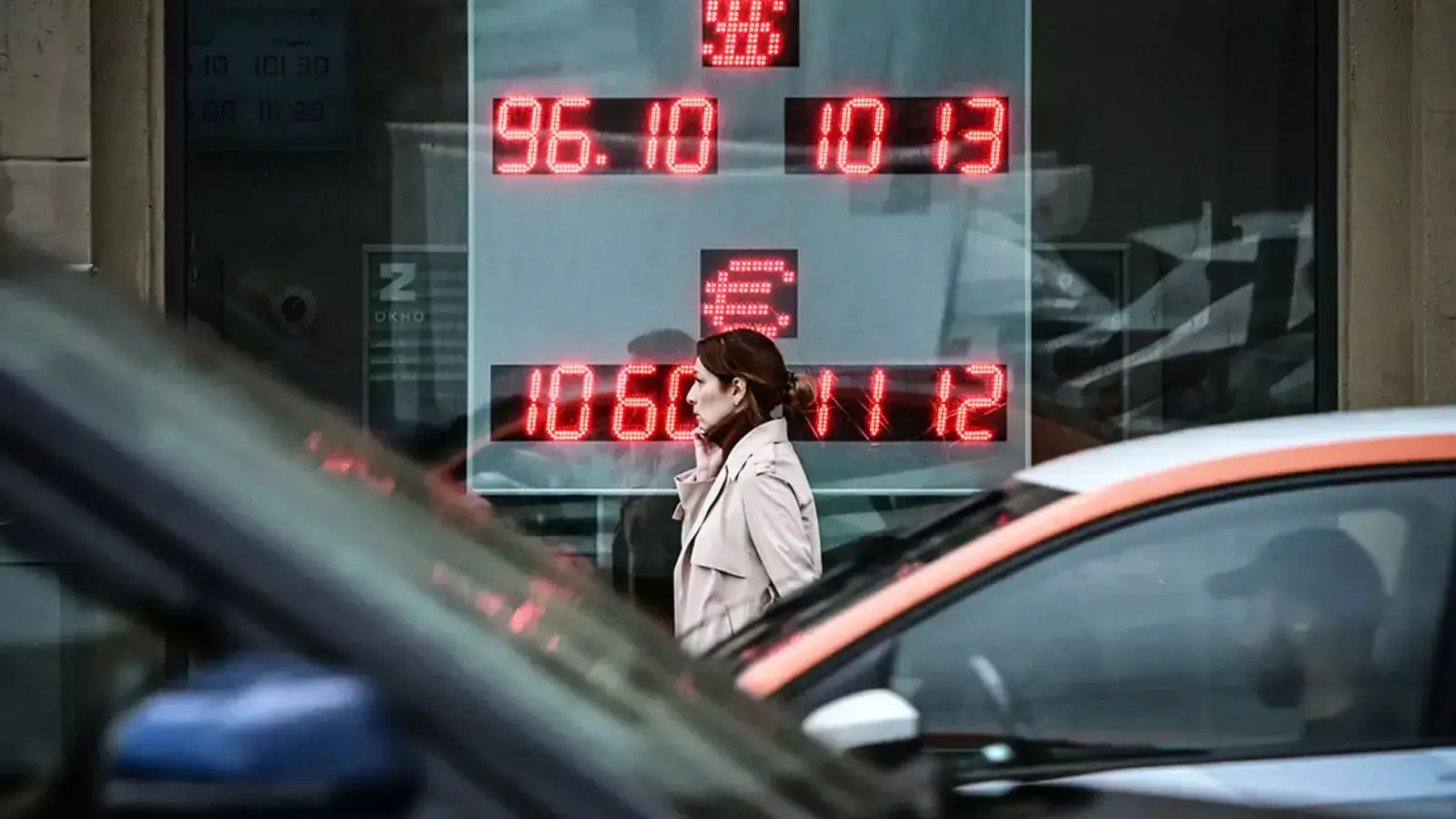 A woman walks past a currency exchange office in Moscow in August 2023.