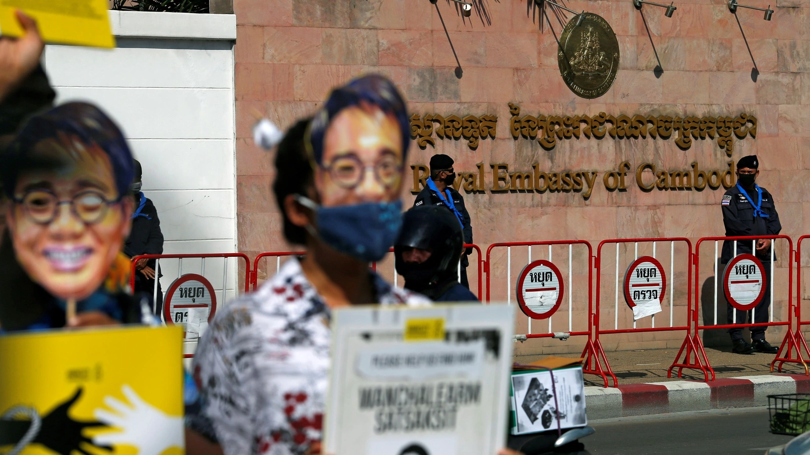 Police officers stand guard during a protest on the six-month anniversary of pro-democracy activist Wanchalearm Satsaksit's abduction, in front of the Cambodian embassy in Bangkok, Thailand, on December 3, 2020.