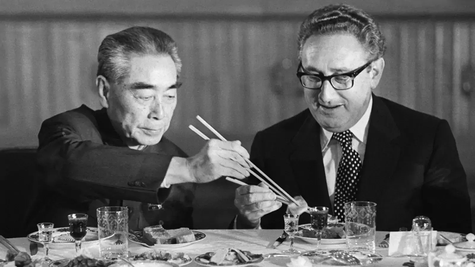 U.S. Secretary of State Henry Kissinger accepts food from Chinese Premier Zhou Enlai during a state banquet in the Great Hall of the People in Beijing in 1973.