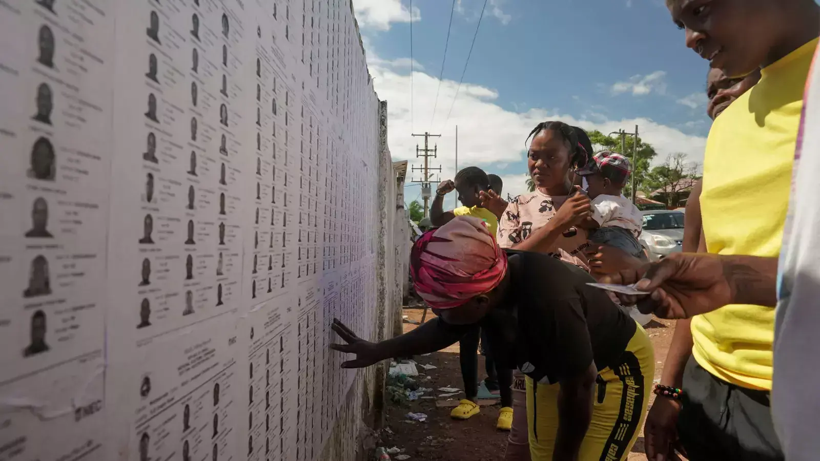 Liberian voters search for their name on electoral lists before they cast their votes during Liberia's presidential election in Monrovia, Liberia on October 10, 2023.