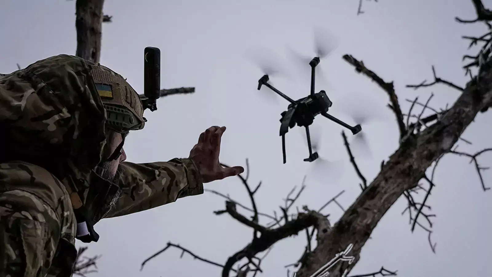 A Ukrainian serviceman releases a drone near Bakhmut, Ukraine.