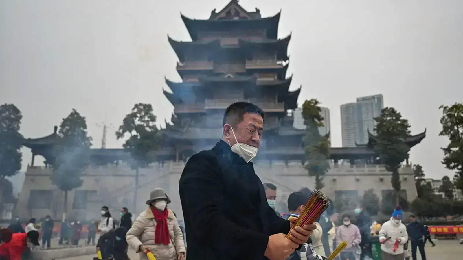 People burn incense at the Buddhist Guiyuan Temple in Wuhan, China.