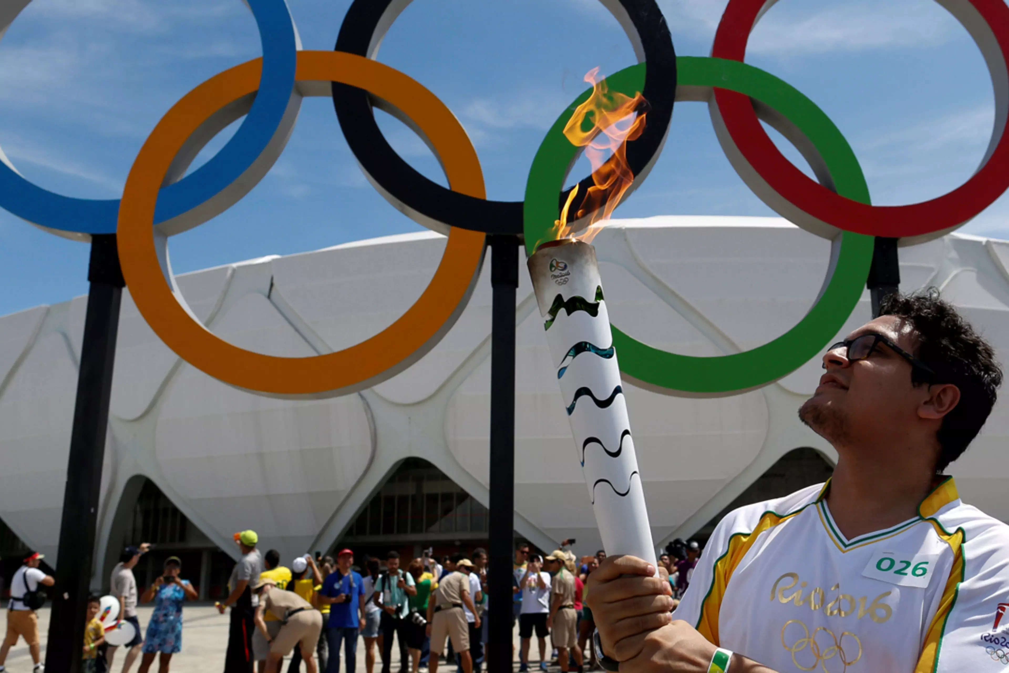 Designer Glauber Penha takes part in the Olympic Flame torch relay outside a stadium in Manaus, Brazil.