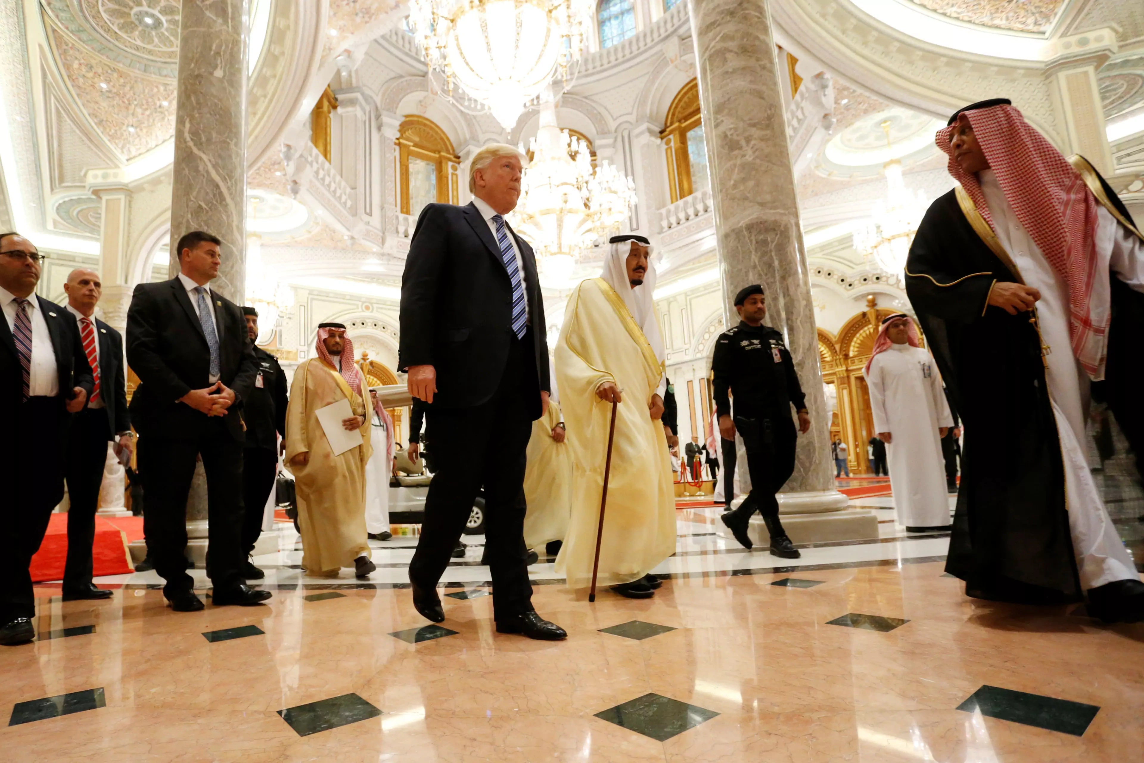 U.S. President Donald J. Trump walks with Saudi King Salman at a summit in Riyadh.