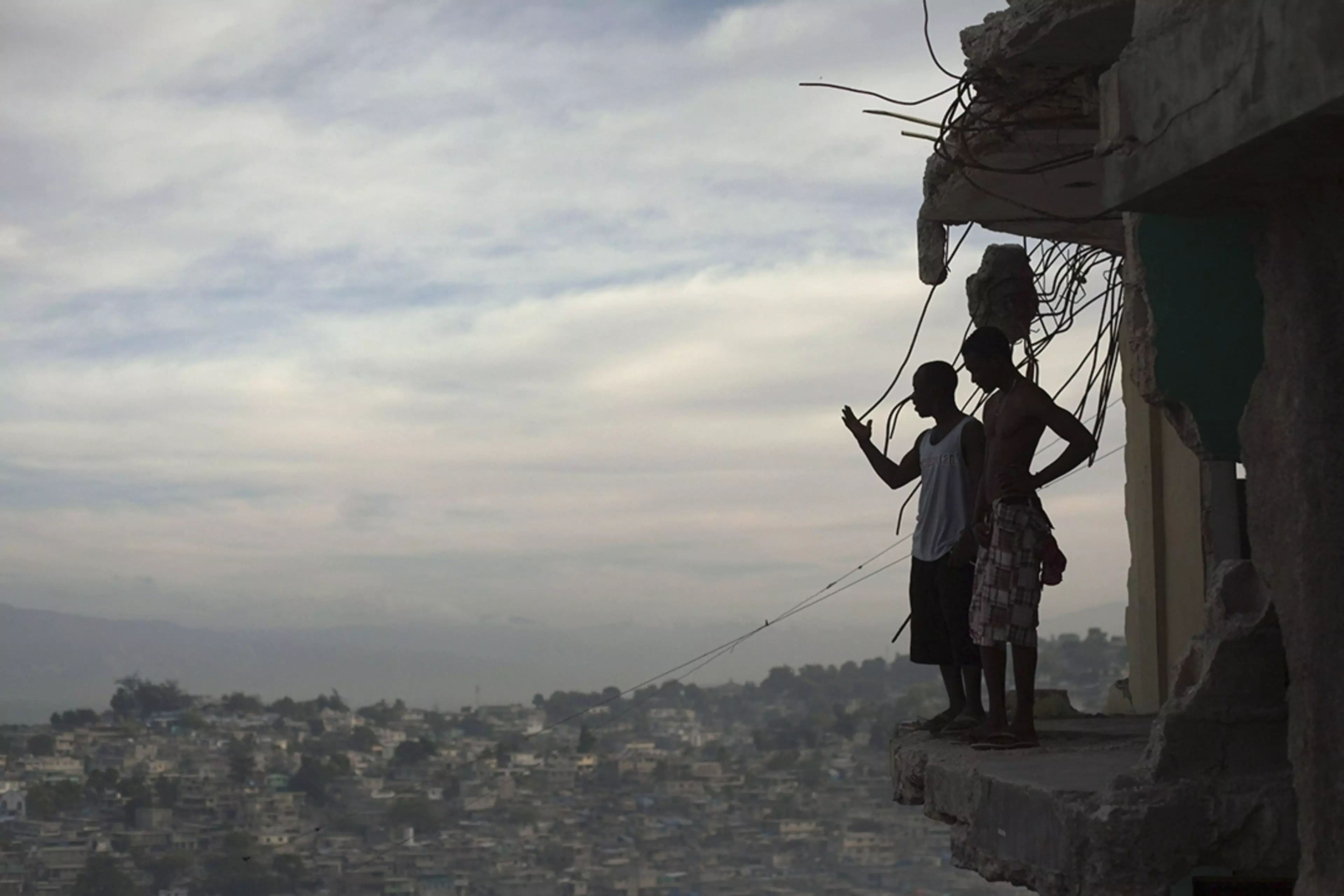 Two men overlook Port-au-Prince in the wake of the 7.0-magnitude earthquake of 2010.