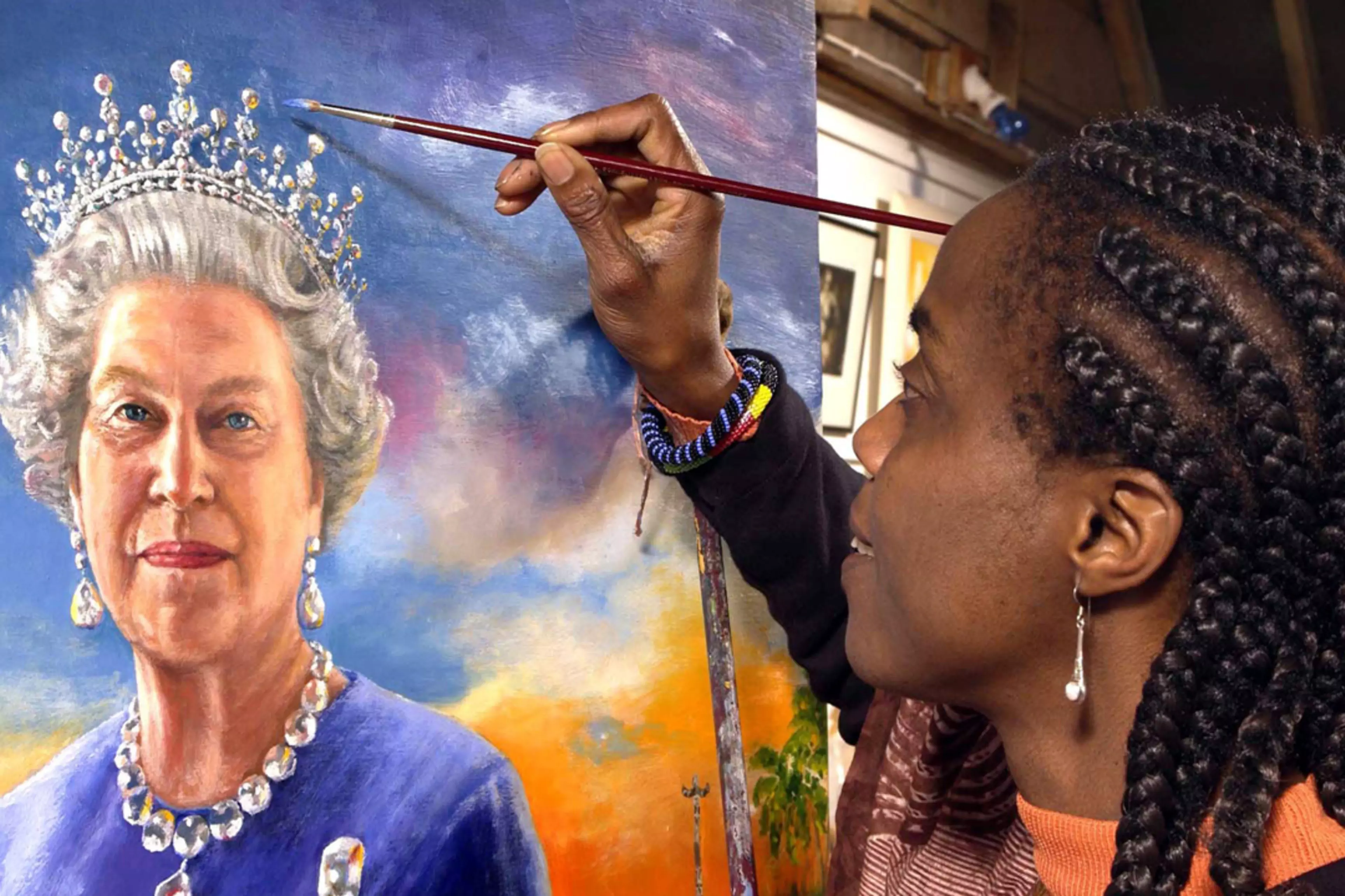 Nigerian artist Chinwe Chukwuogo-Roy works on a portrait of Britain's Queen Elizabeth II.