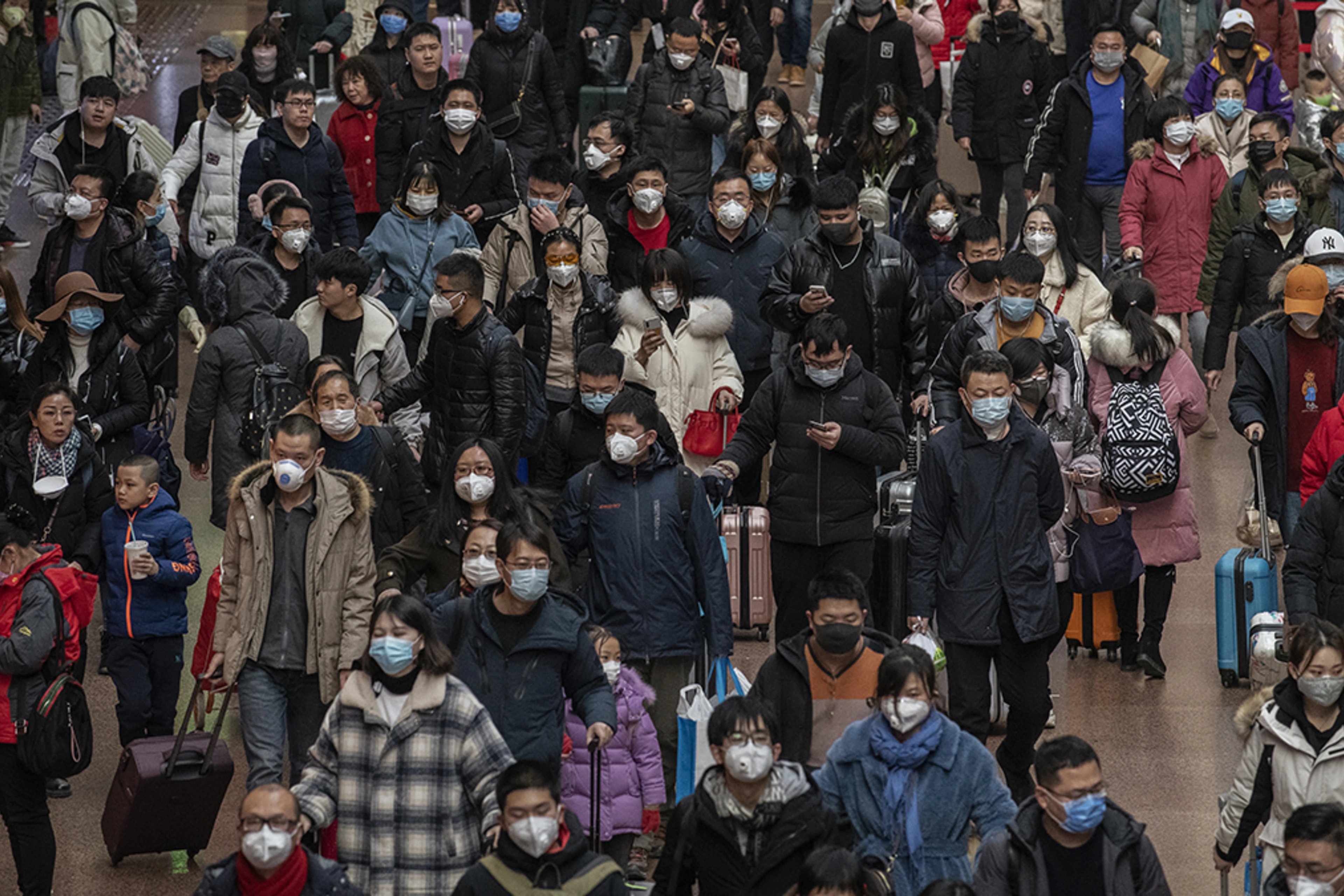 Chinese passengers arrive at a Beijing railway station amid the coronavirus outbreak.