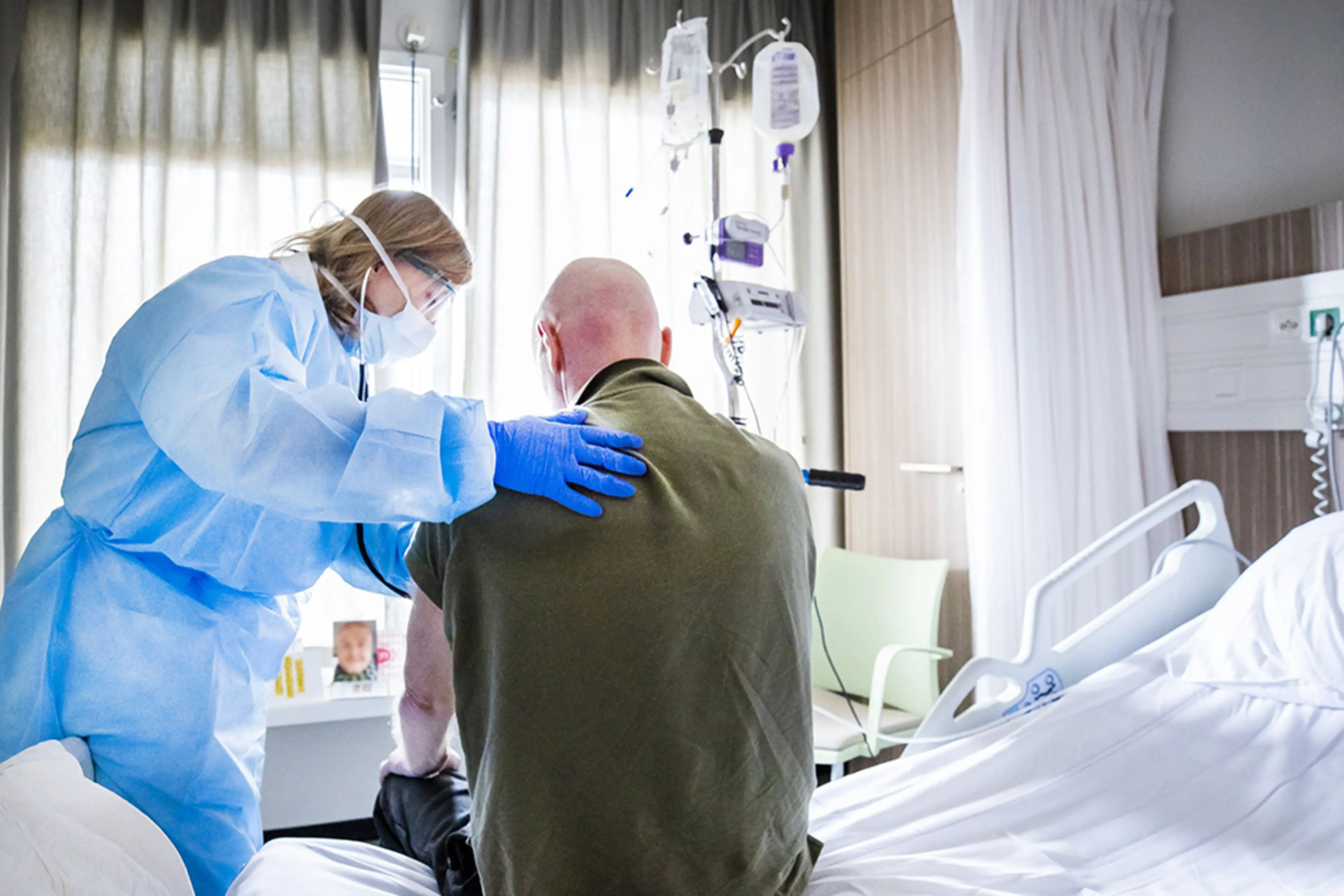 A physician attends to a patient recovering from COVID-19 at a Dutch hospital.