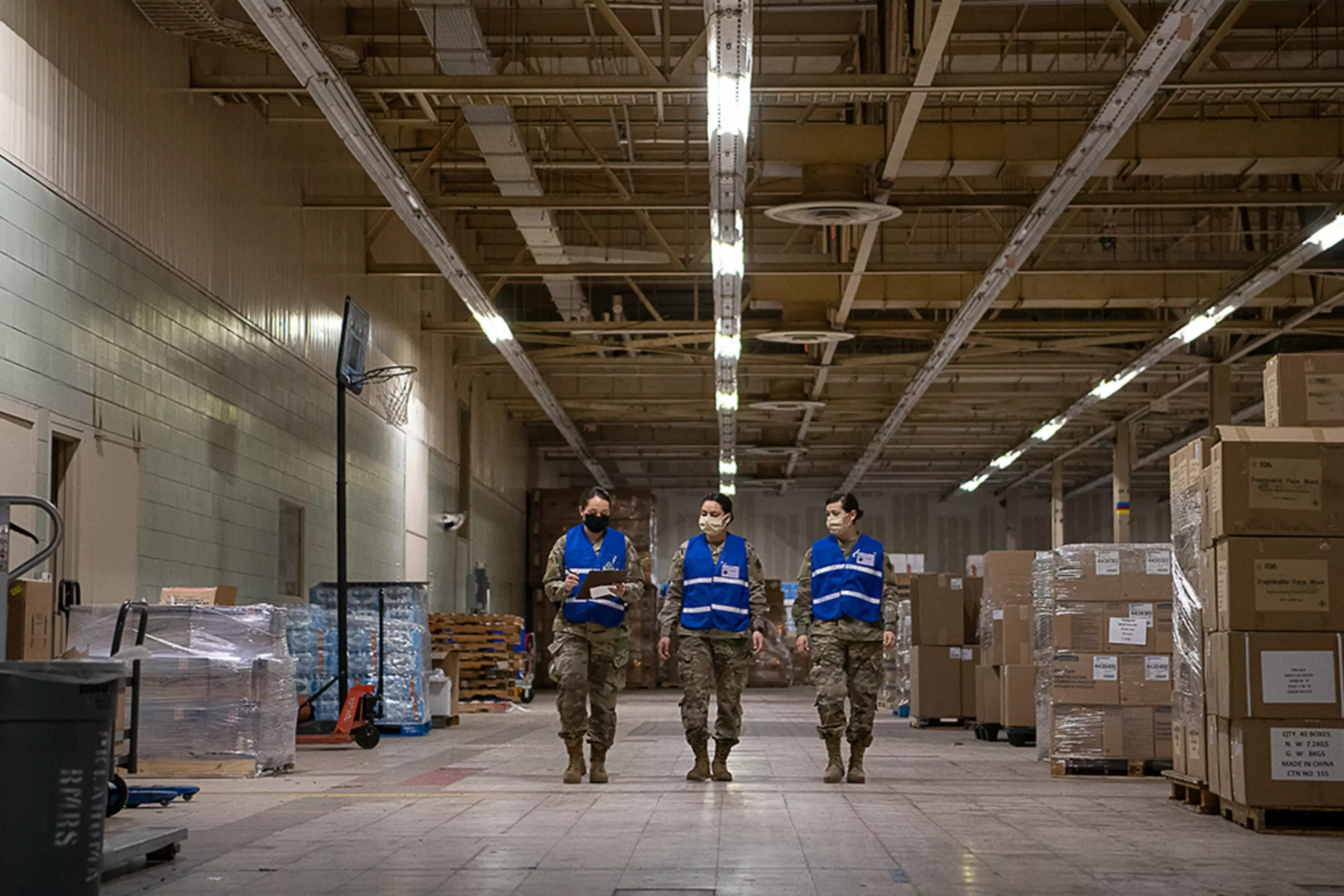 Members of the Oklahoma National Guard walk in the Strategic National Stockpile Warehouse.