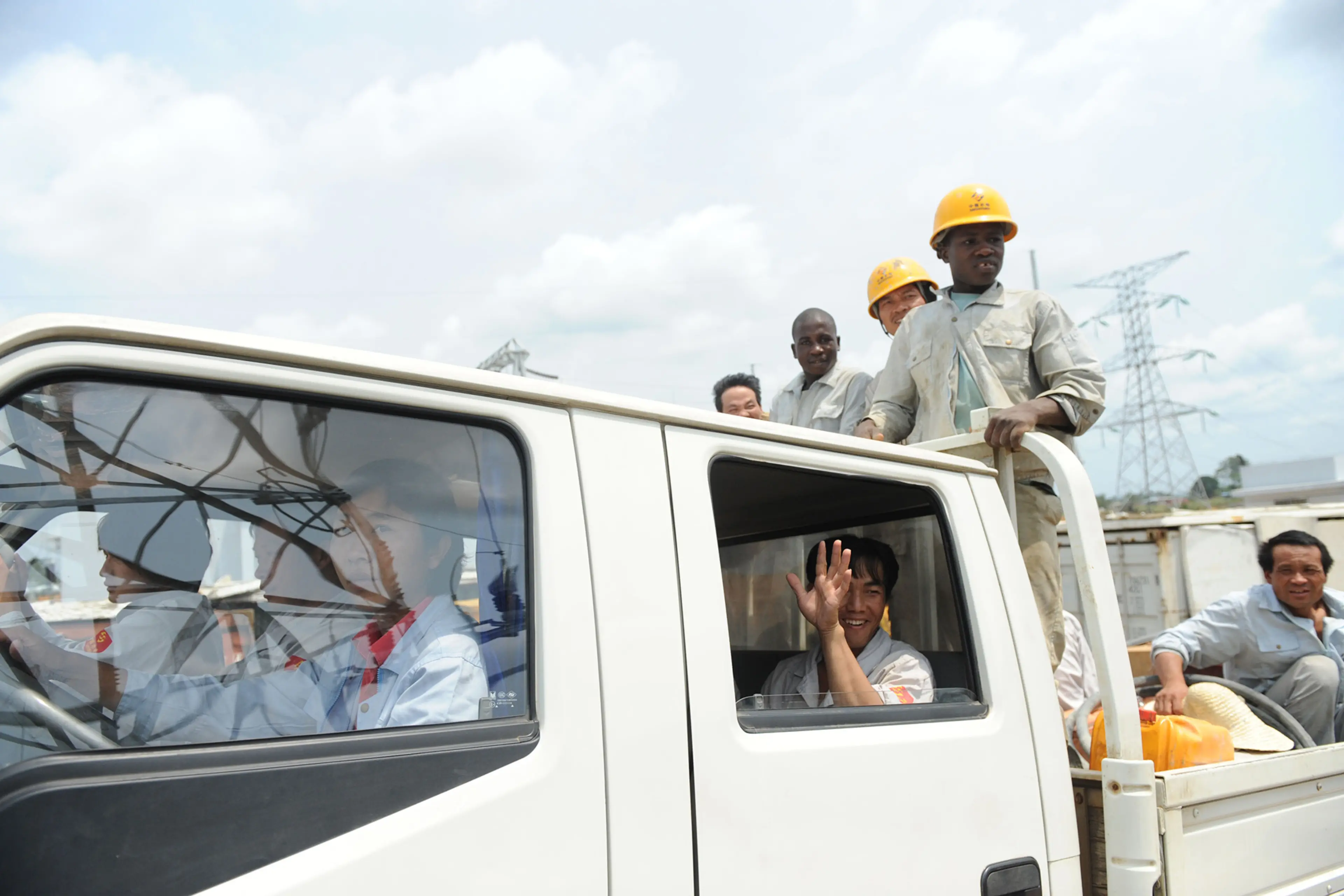 People from China and Burkina Faso work for a Chinese company in Equatorial Guinea. 