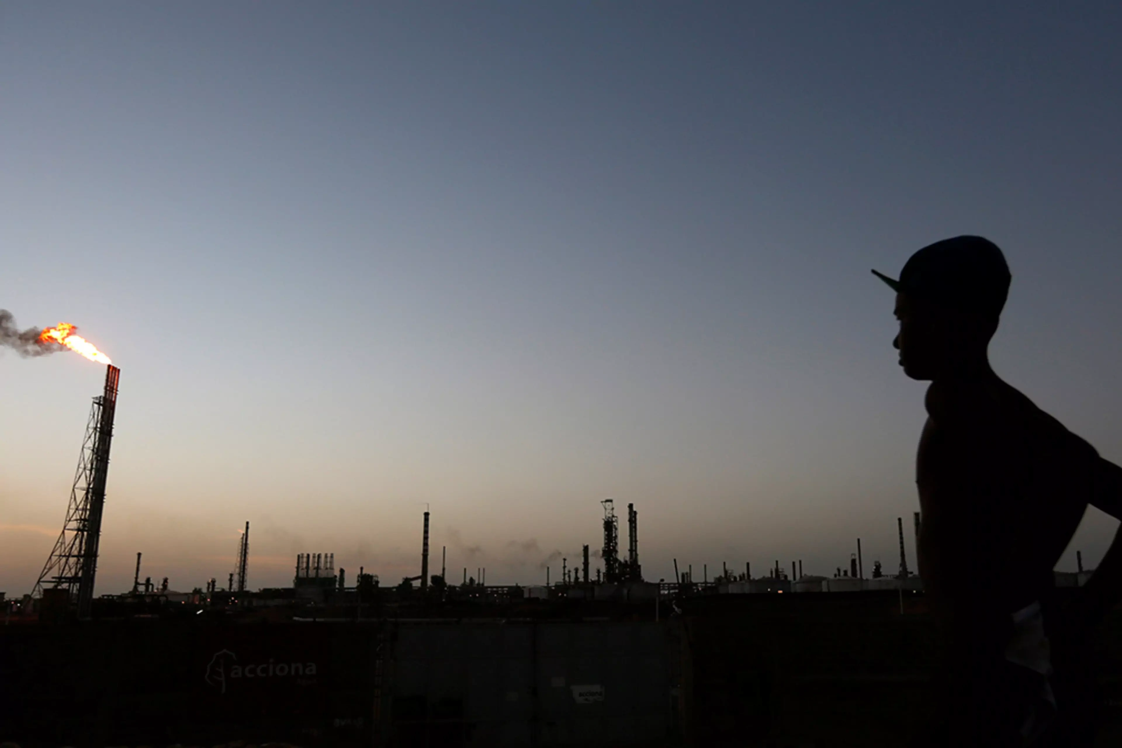 A man stands near a state-owned refinery in Punto Fijo, Venezuela.