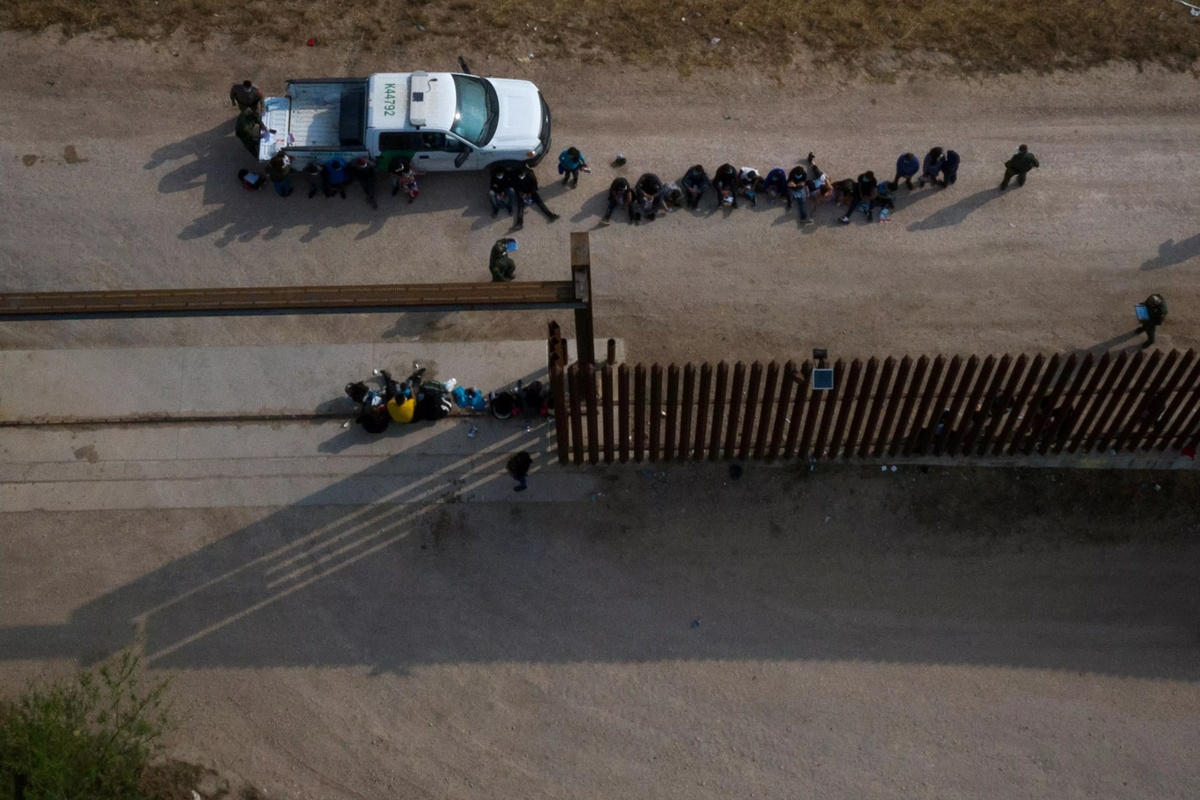 Unaccompanied children seeking U.S. asylum sit near a Border Patrol vehicle in Penitas, Texas.