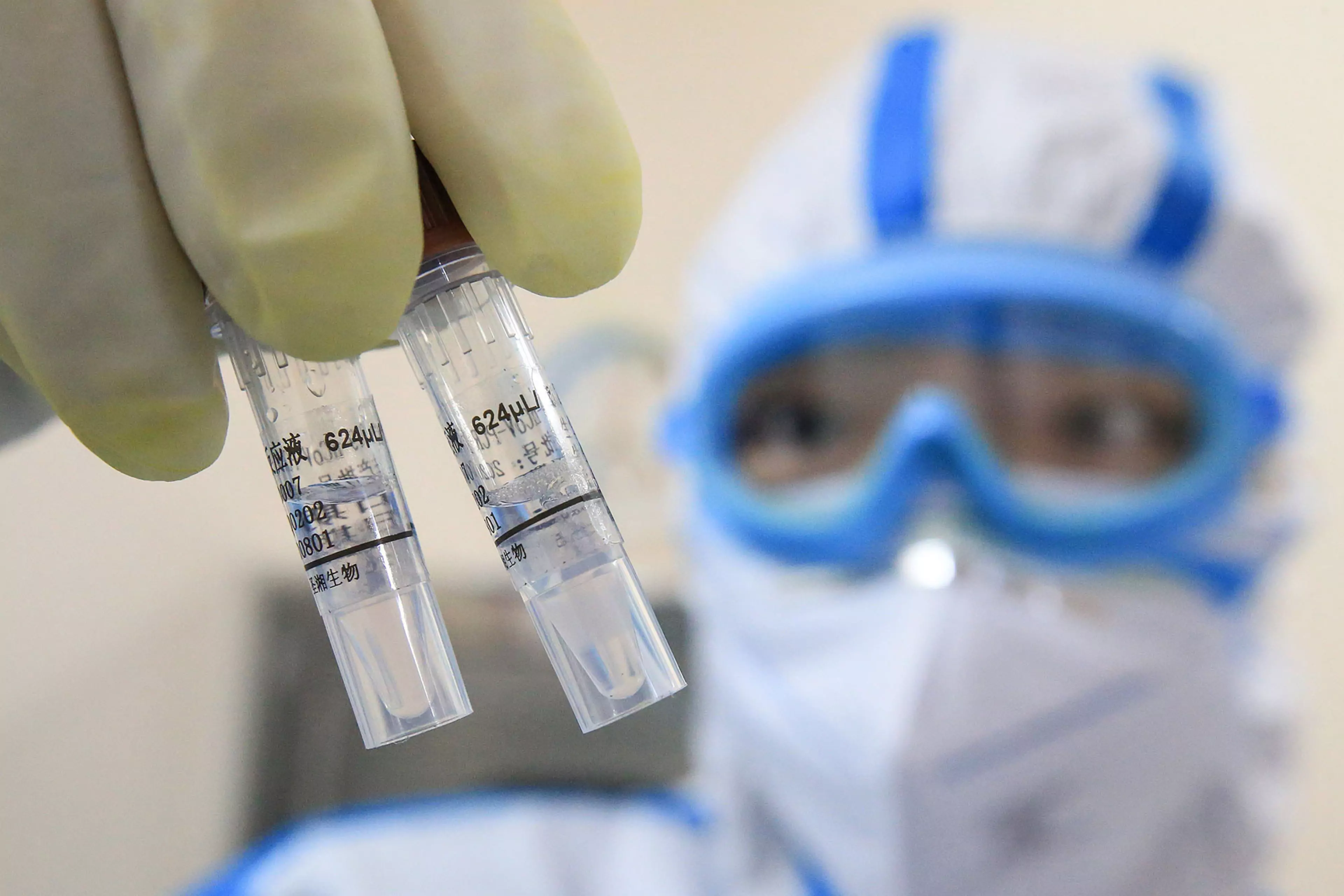 A technician holds virus samples at a laboratory in Hengyang, China, in February 2020.