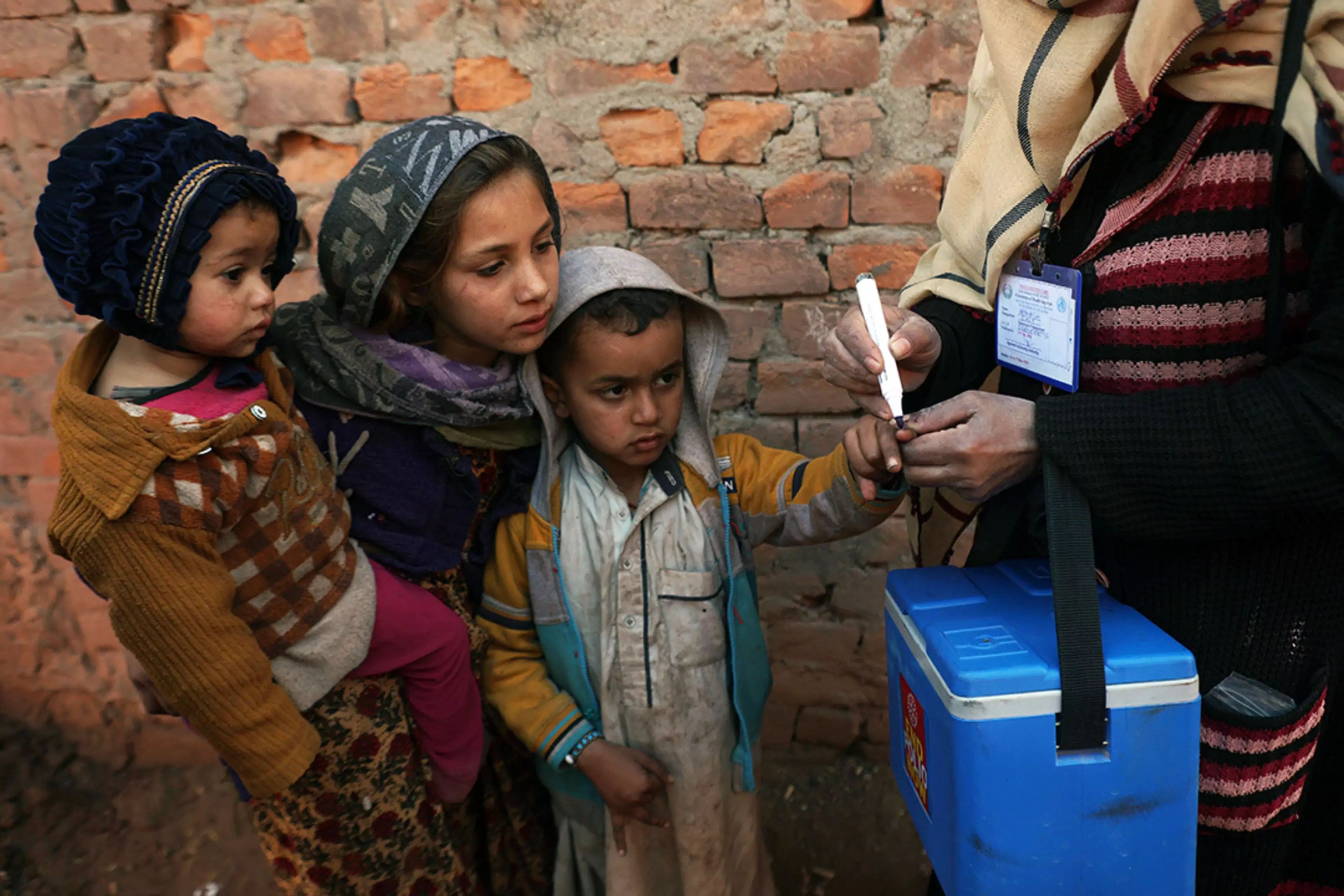 A health worker marks a child’s finger during a vaccination campaign near Islamabad.