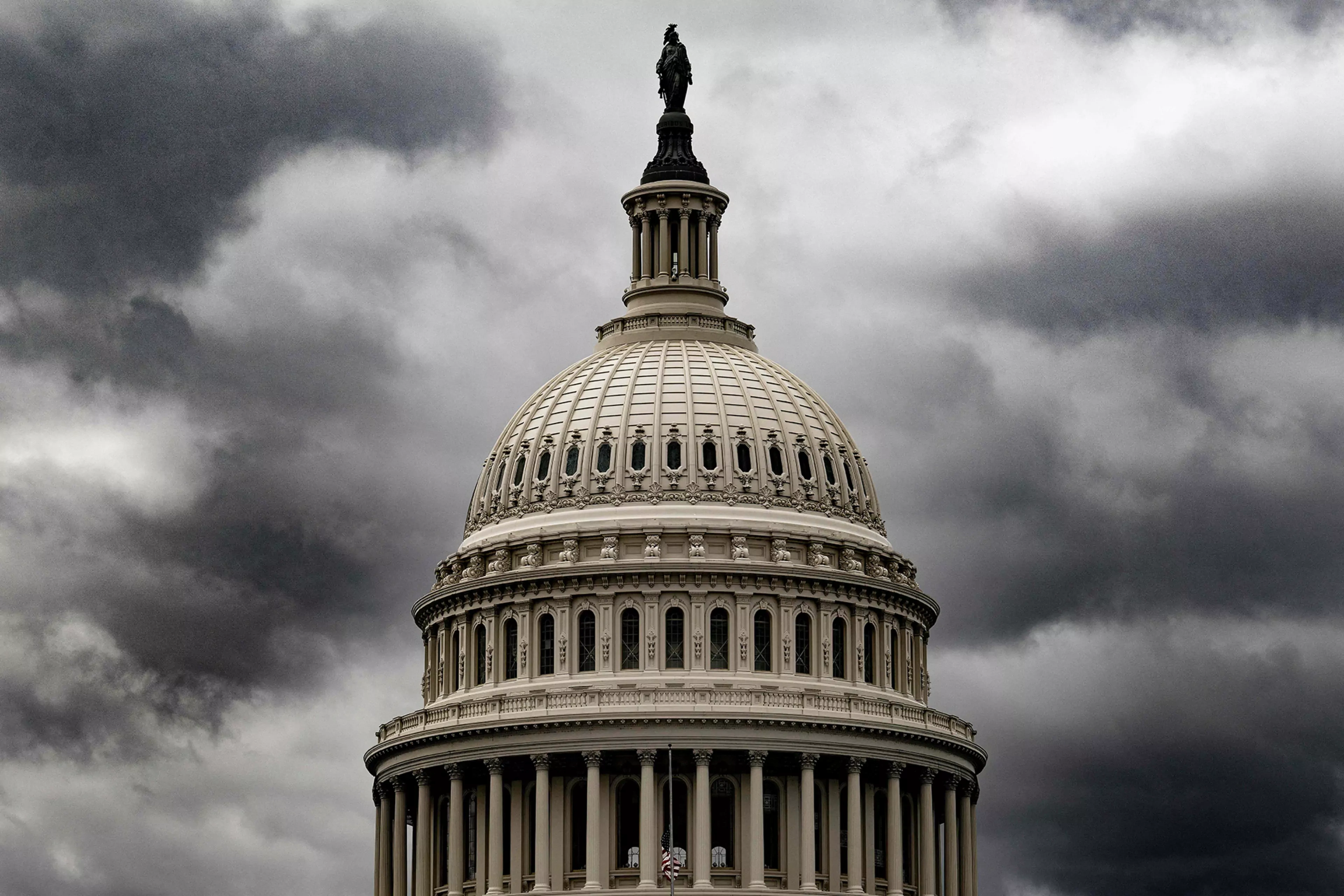 Storm clouds hover above the U.S. Capitol.