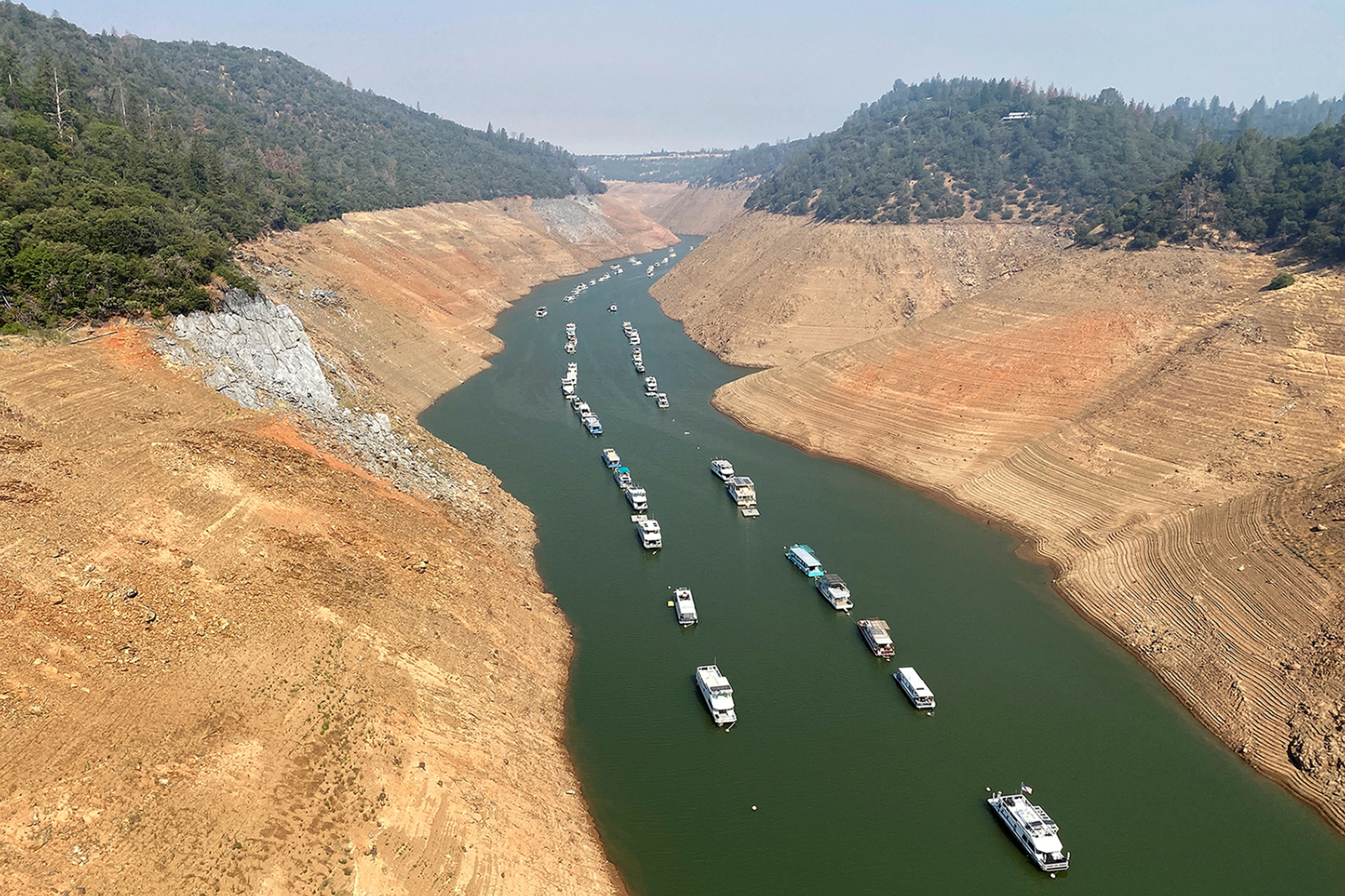Boats and houseboats are moored at record low water at Lake Oroville near Pentz, California