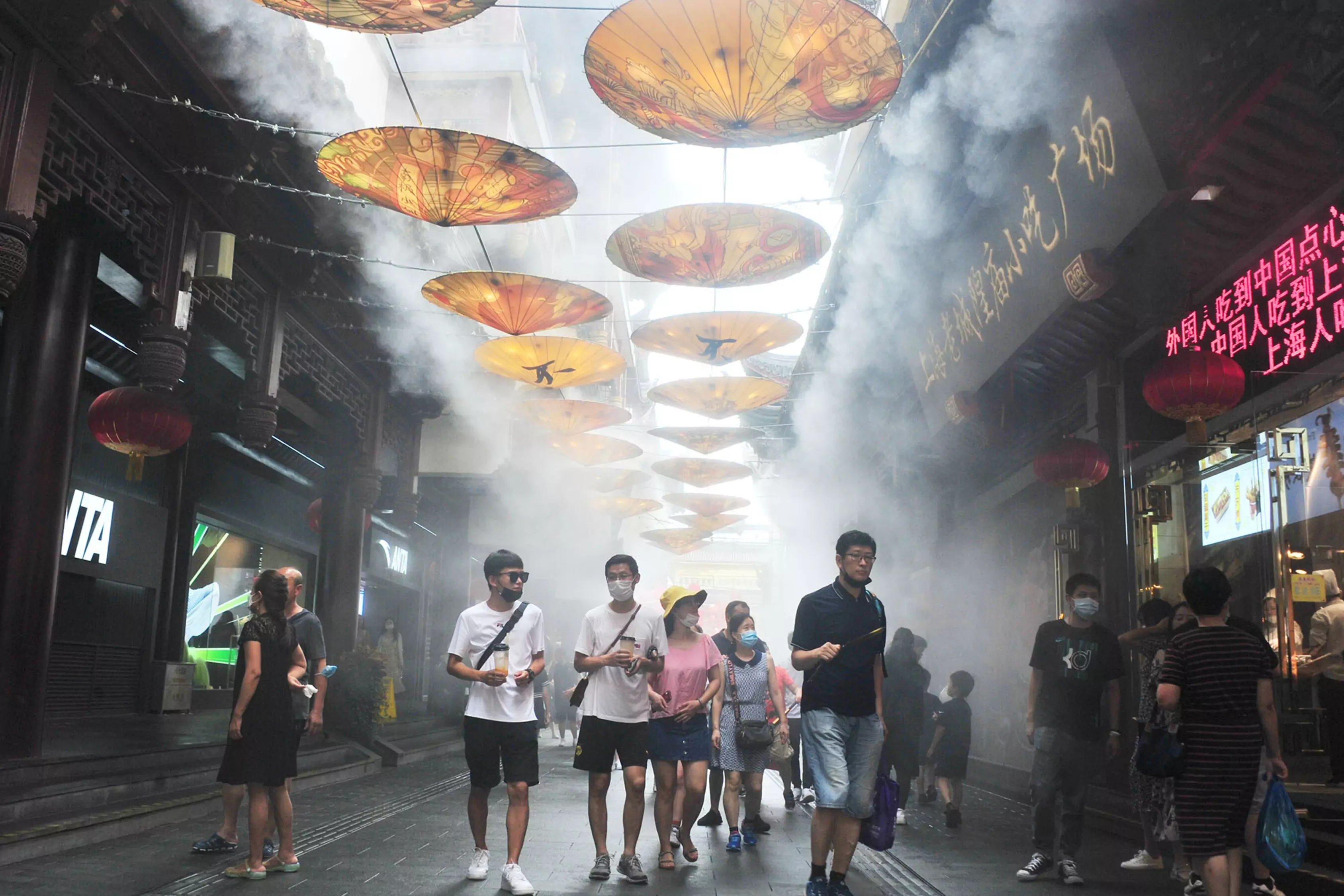 People walk under cooling fog at Yu Yuan Garden during hot weather on July 19, 2020 in Shanghai, China. 